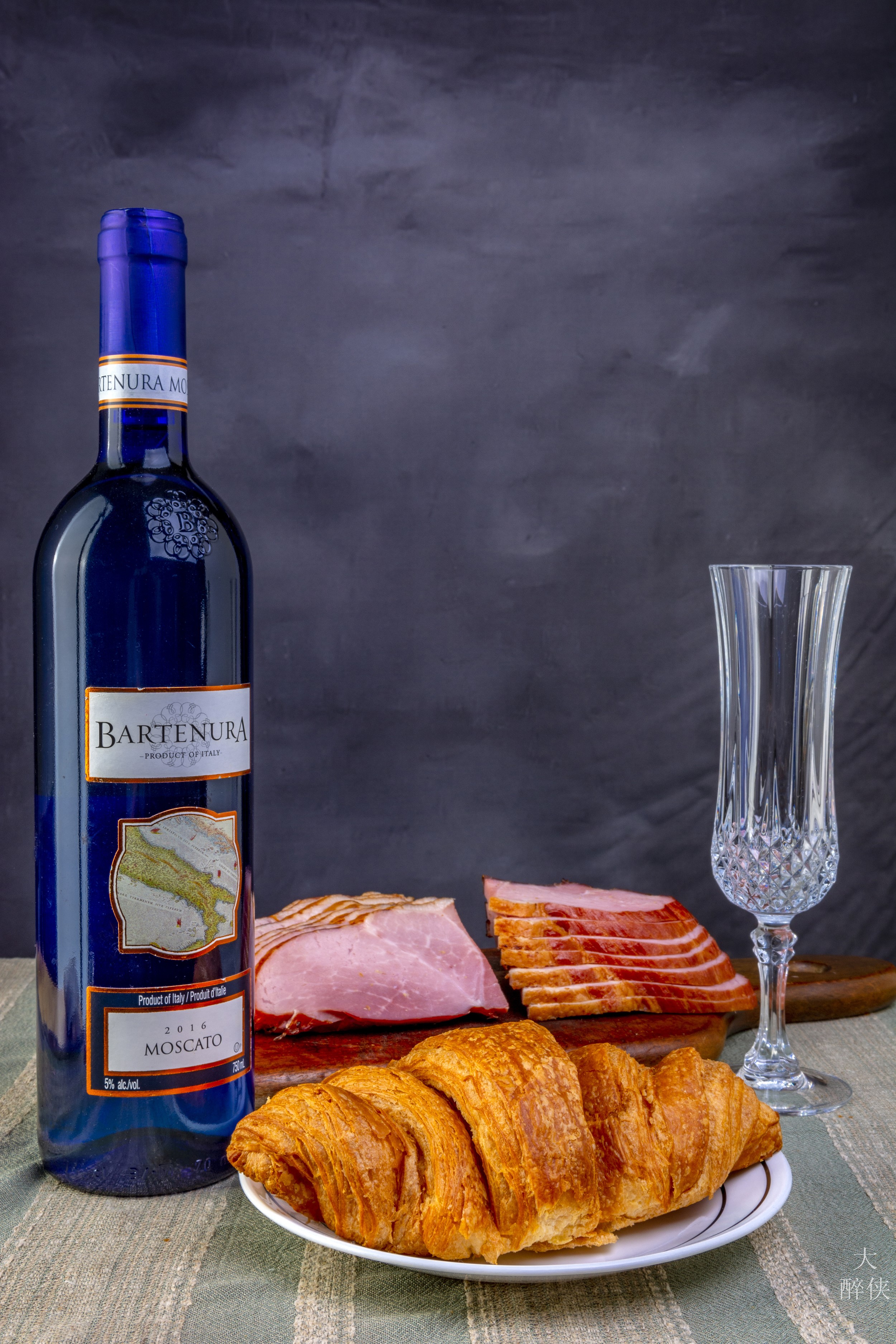 Bartenura Moscato wine bottle with croissant and ham HD Phone Wallpaper