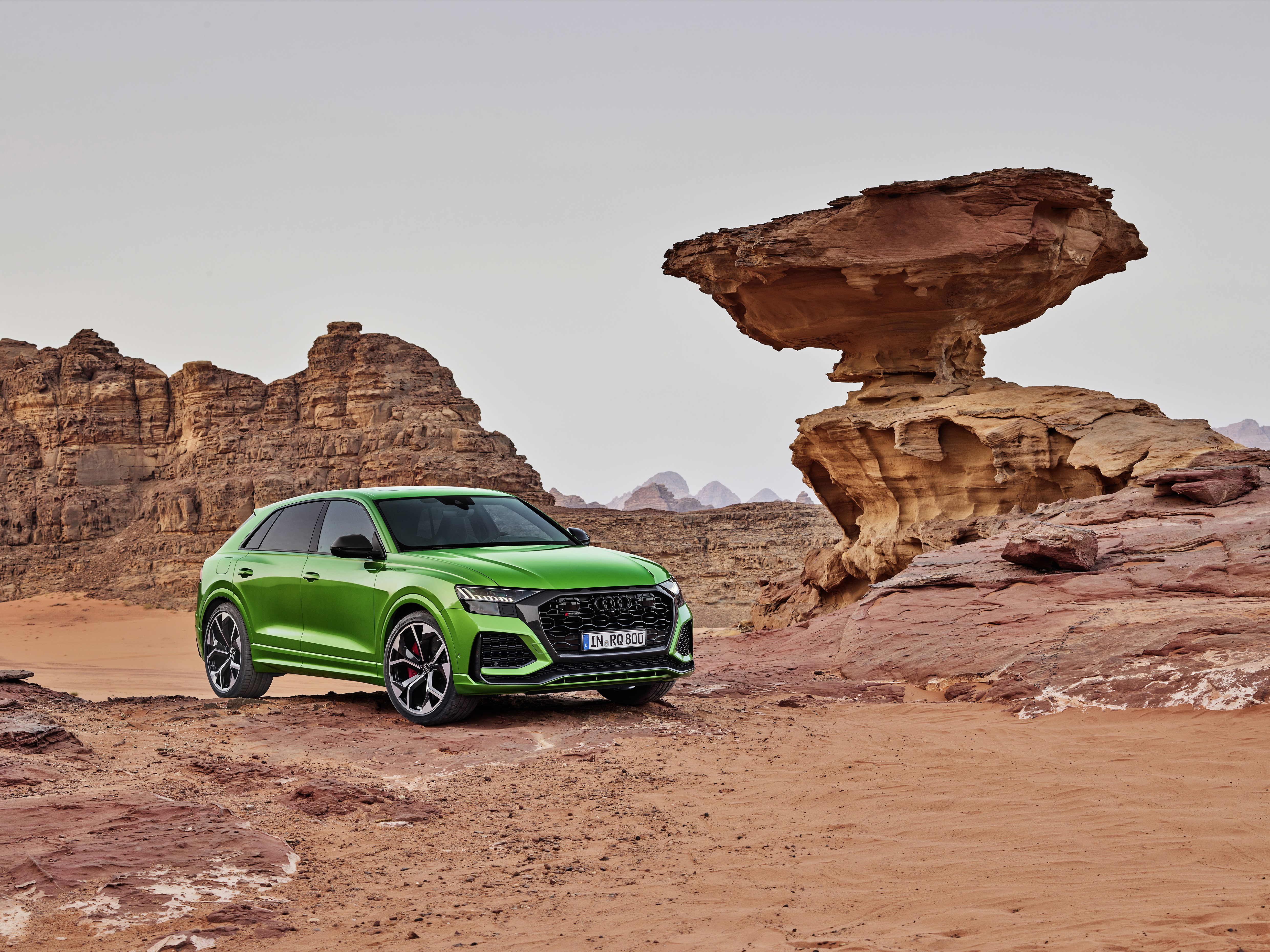 Green Audi RS Q8 in a desert landscape HD Wallpaper