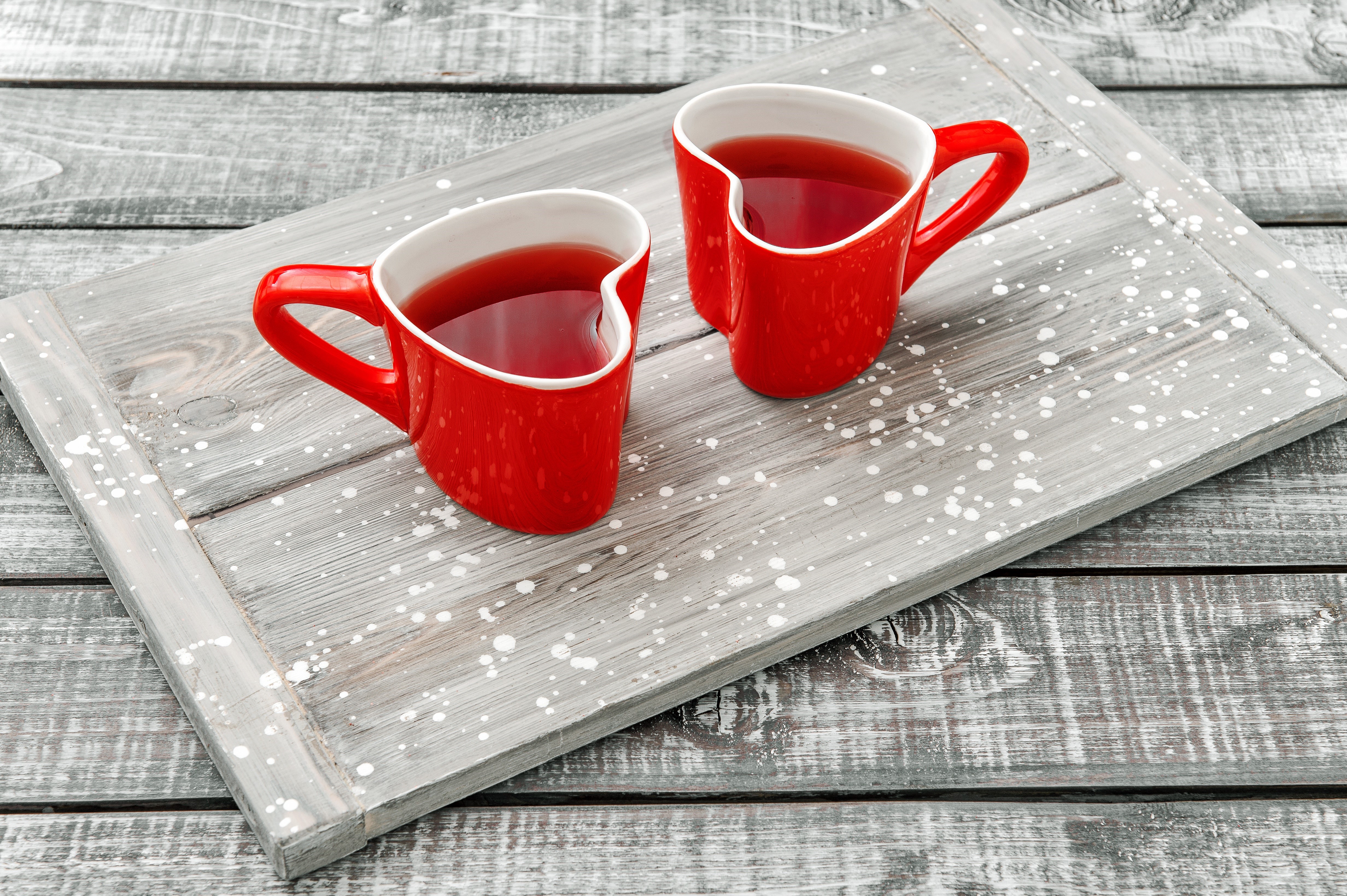 Two red heart-shaped mugs of tea on a tray HD Wallpaper