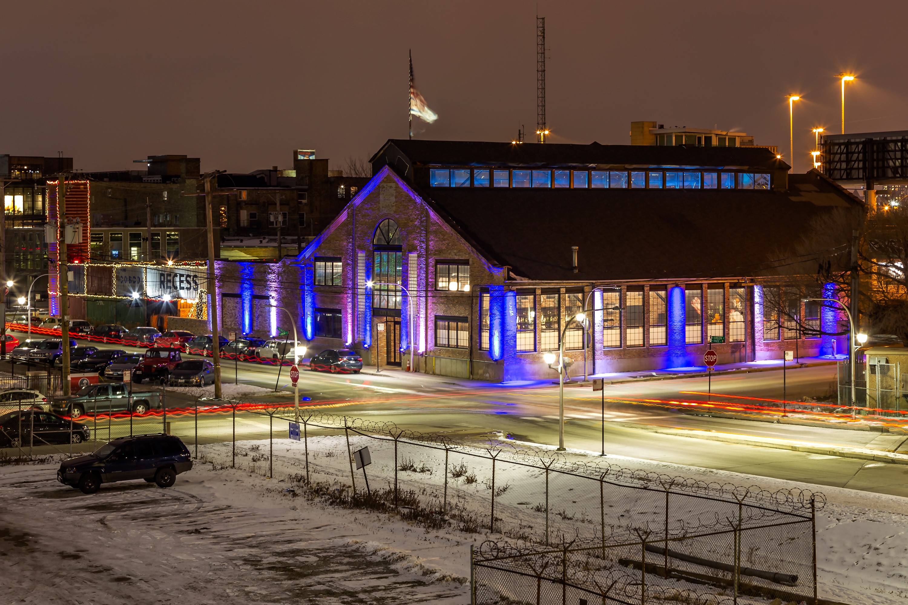 Brick building with blue lights at night in winter HD Wallpaper