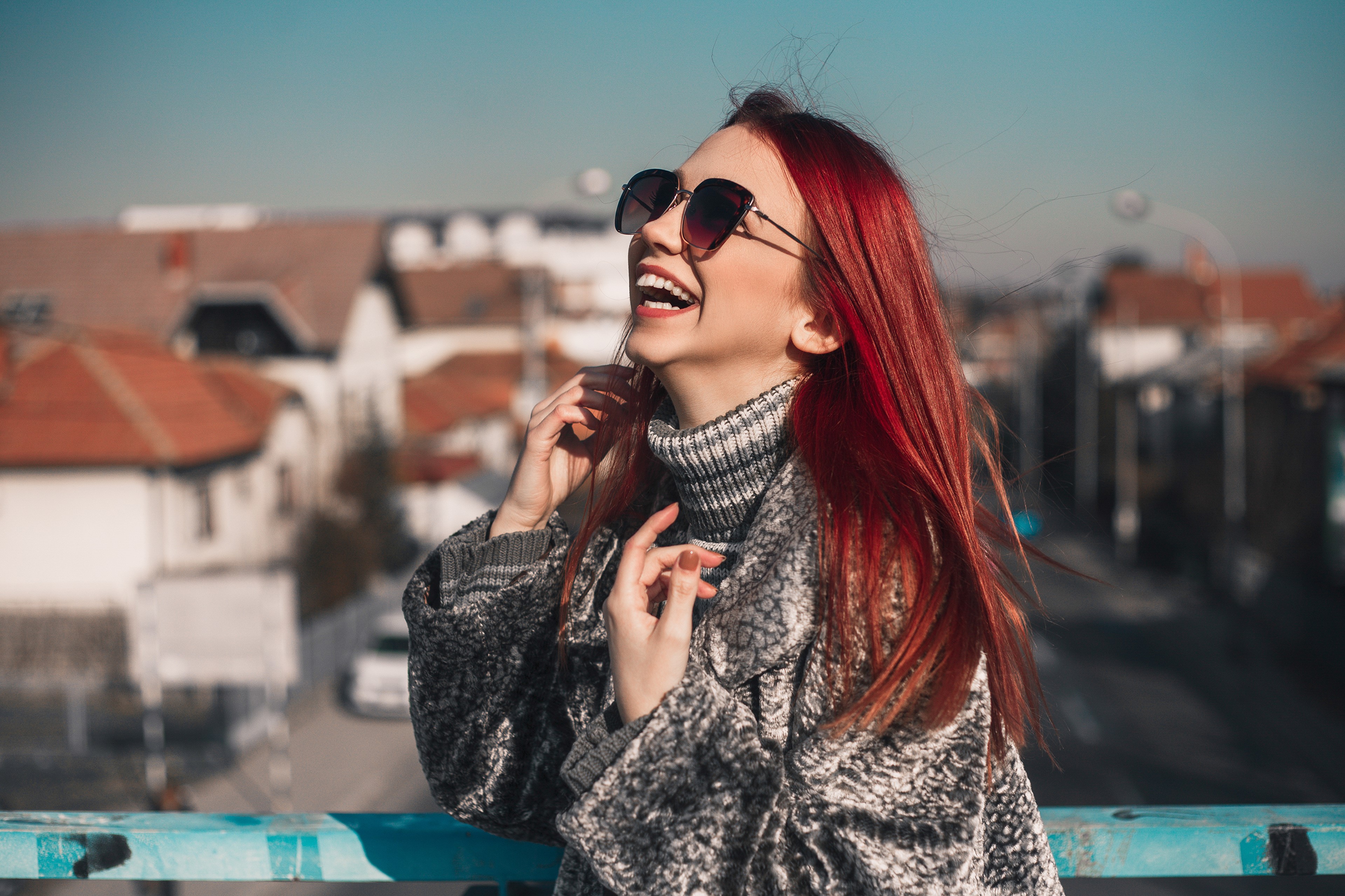 Redhead girl with glasses laughing outdoors HD Wallpaper