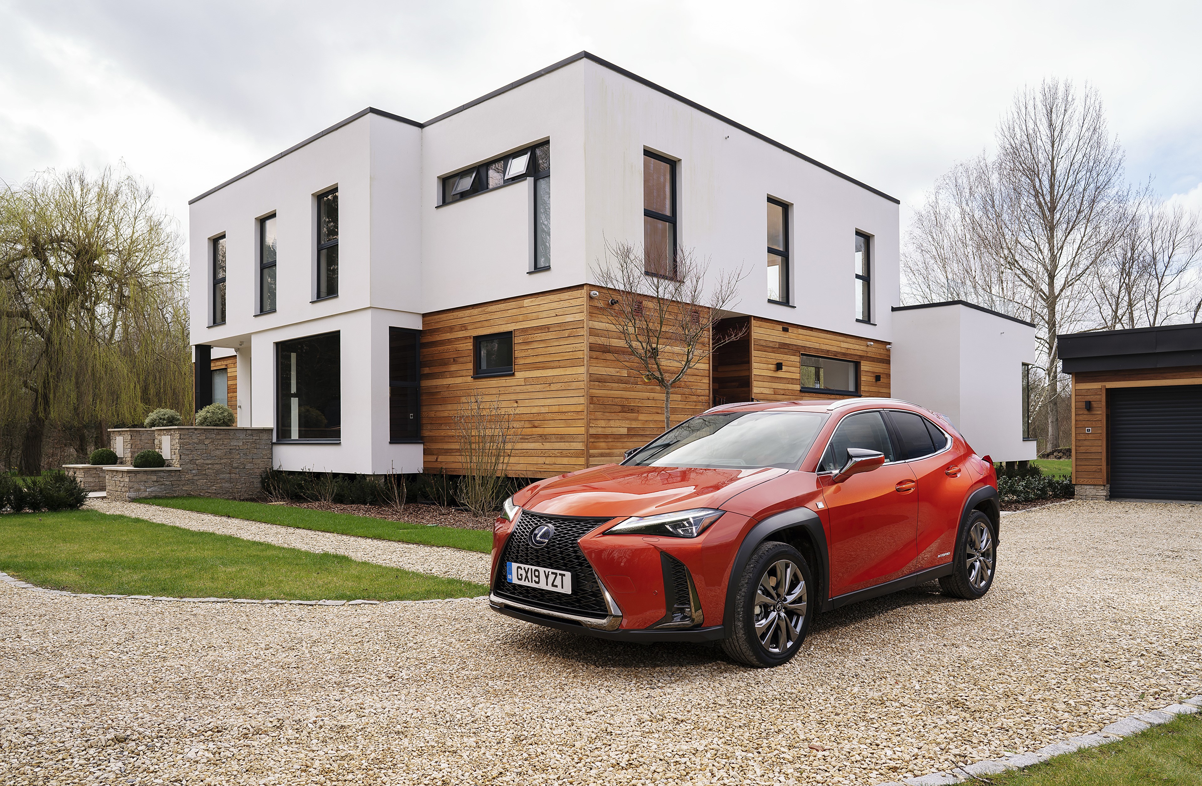 Orange 2019 Lexus UX 250h F SPORT parked in front of modern house HD Wallpaper