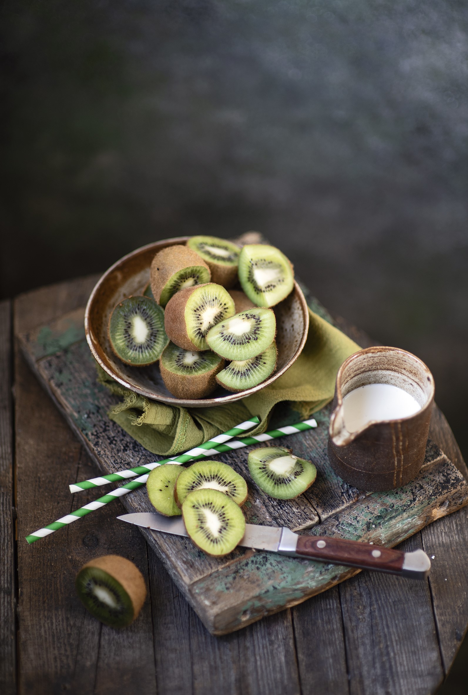 Sliced kiwis with milk and a knife on wood HD Phone Wallpaper