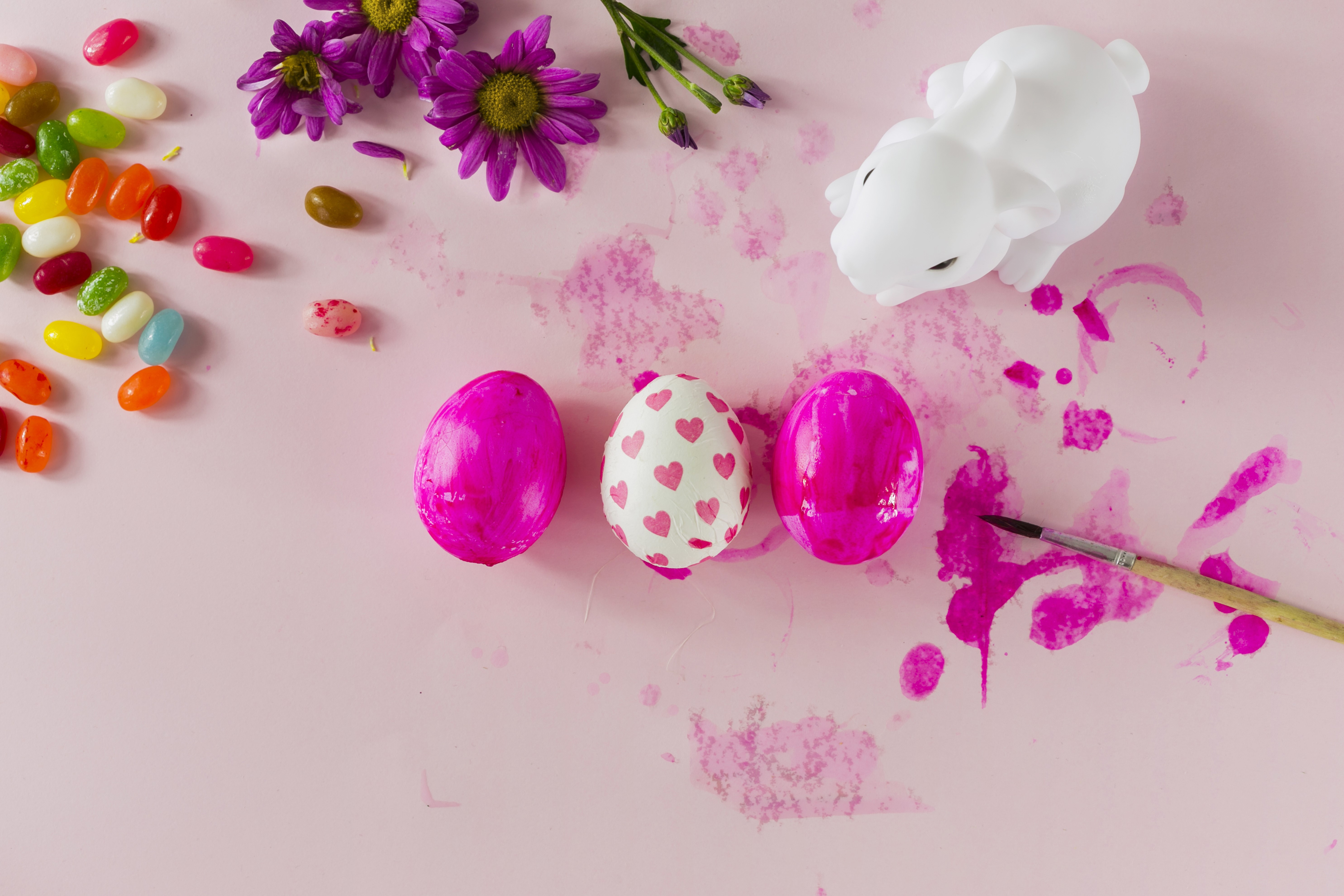 Easter eggs and candy with flowers and a bunny HD Wallpaper