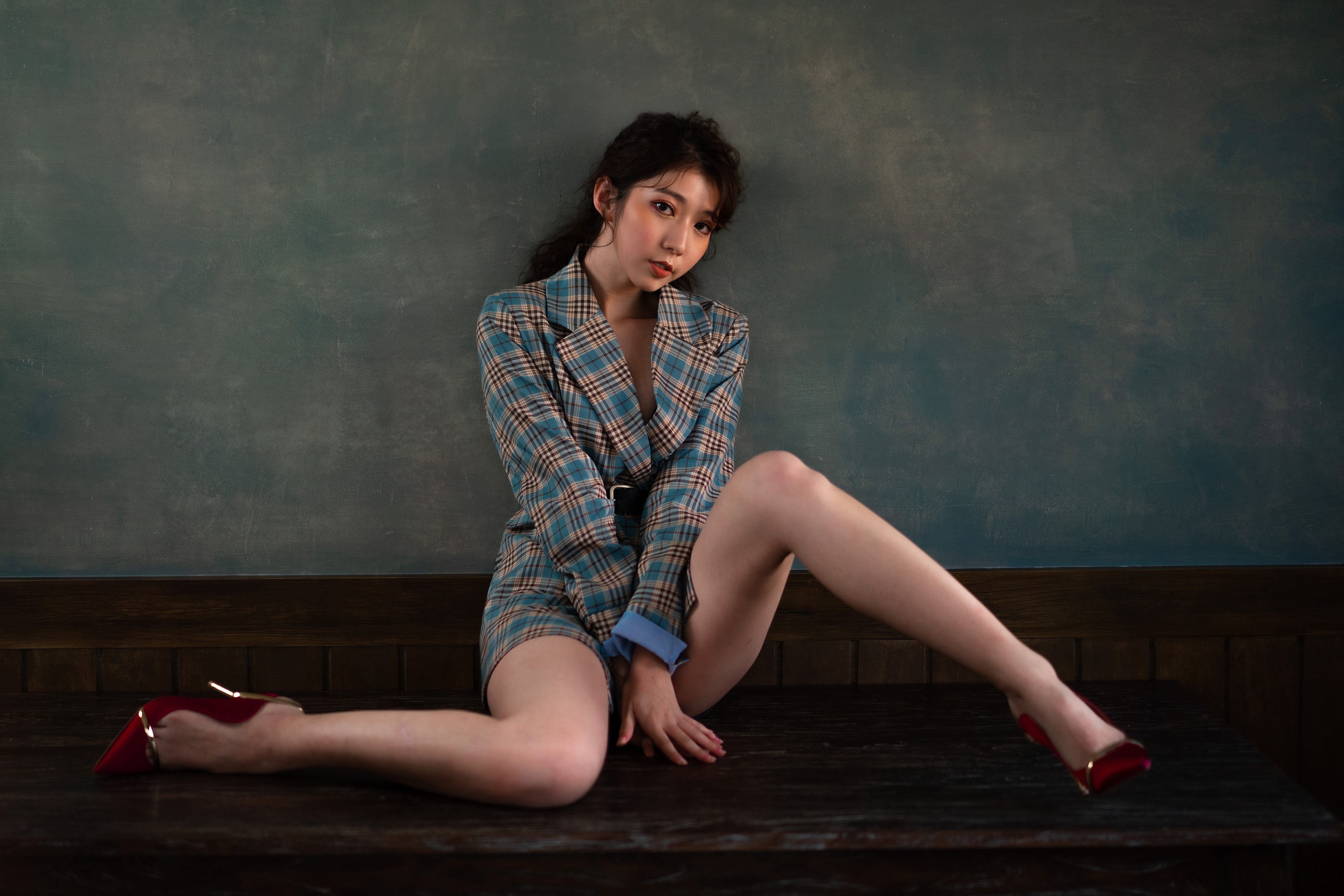 4K Asian Woman Sitting Pose with Legs Extended HD Wallpaper