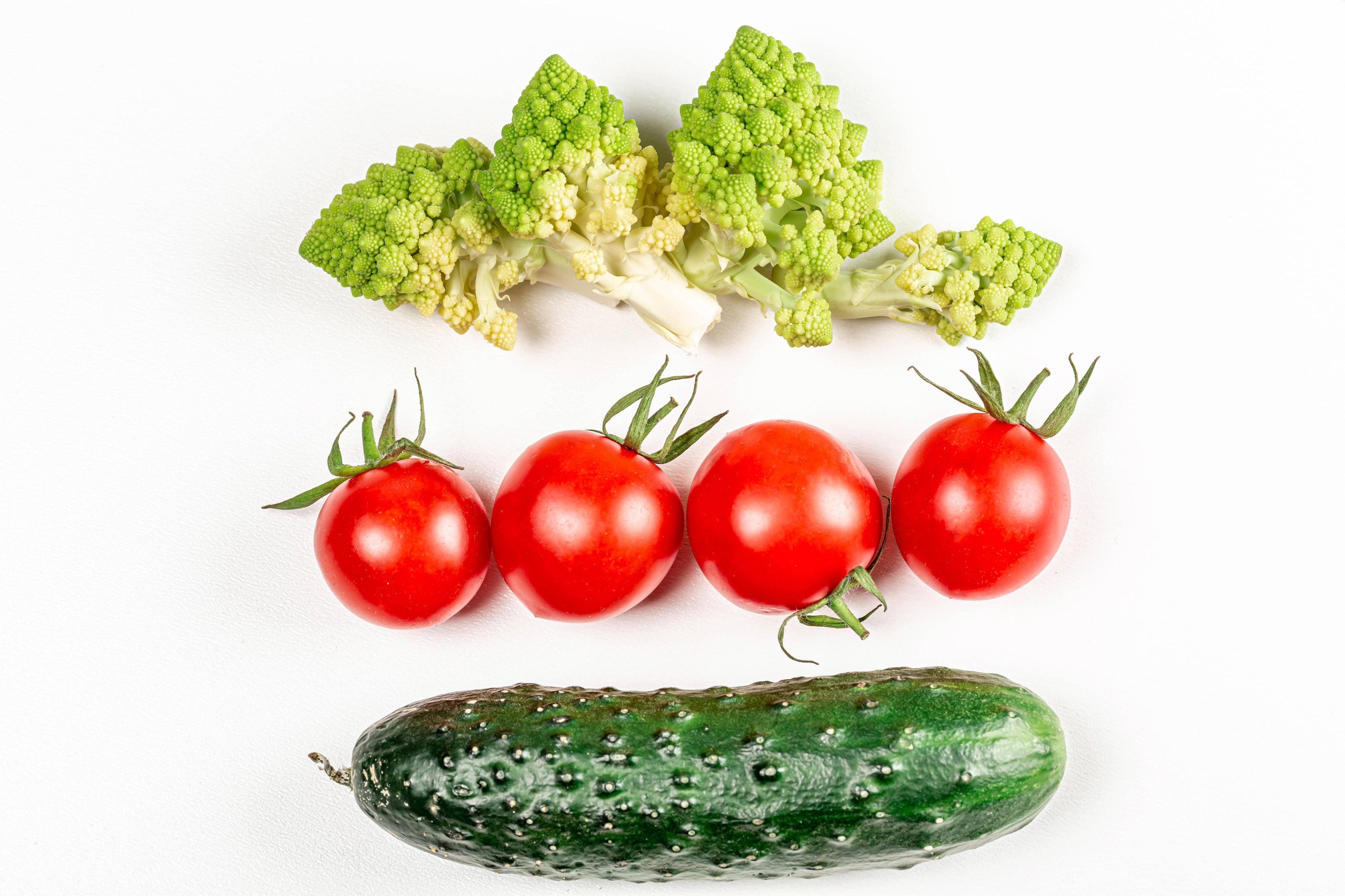 Romanesco broccoli, tomatoes, and cucumber on white background HD Wallpaper