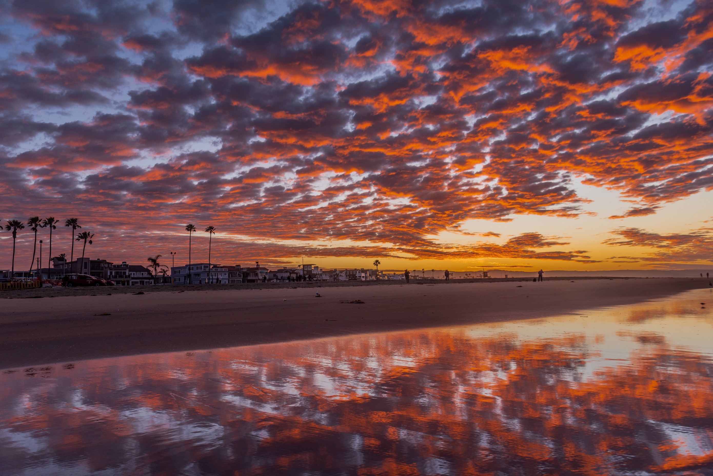 Sunset over Newport Beach with colorful clouds and reflection HD Wallpaper