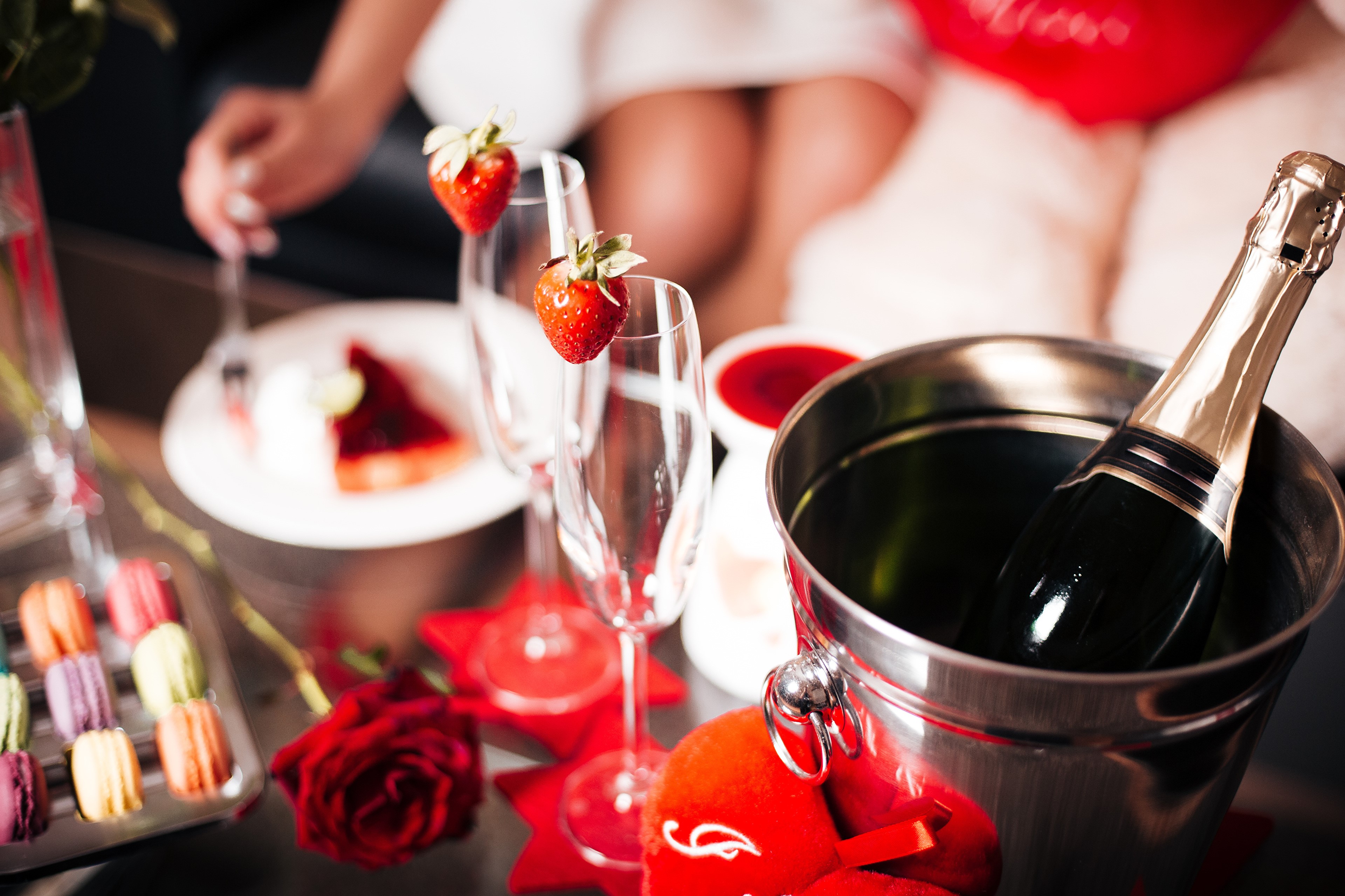 Champagne bottle in bucket with strawberries and macarons HD Wallpaper