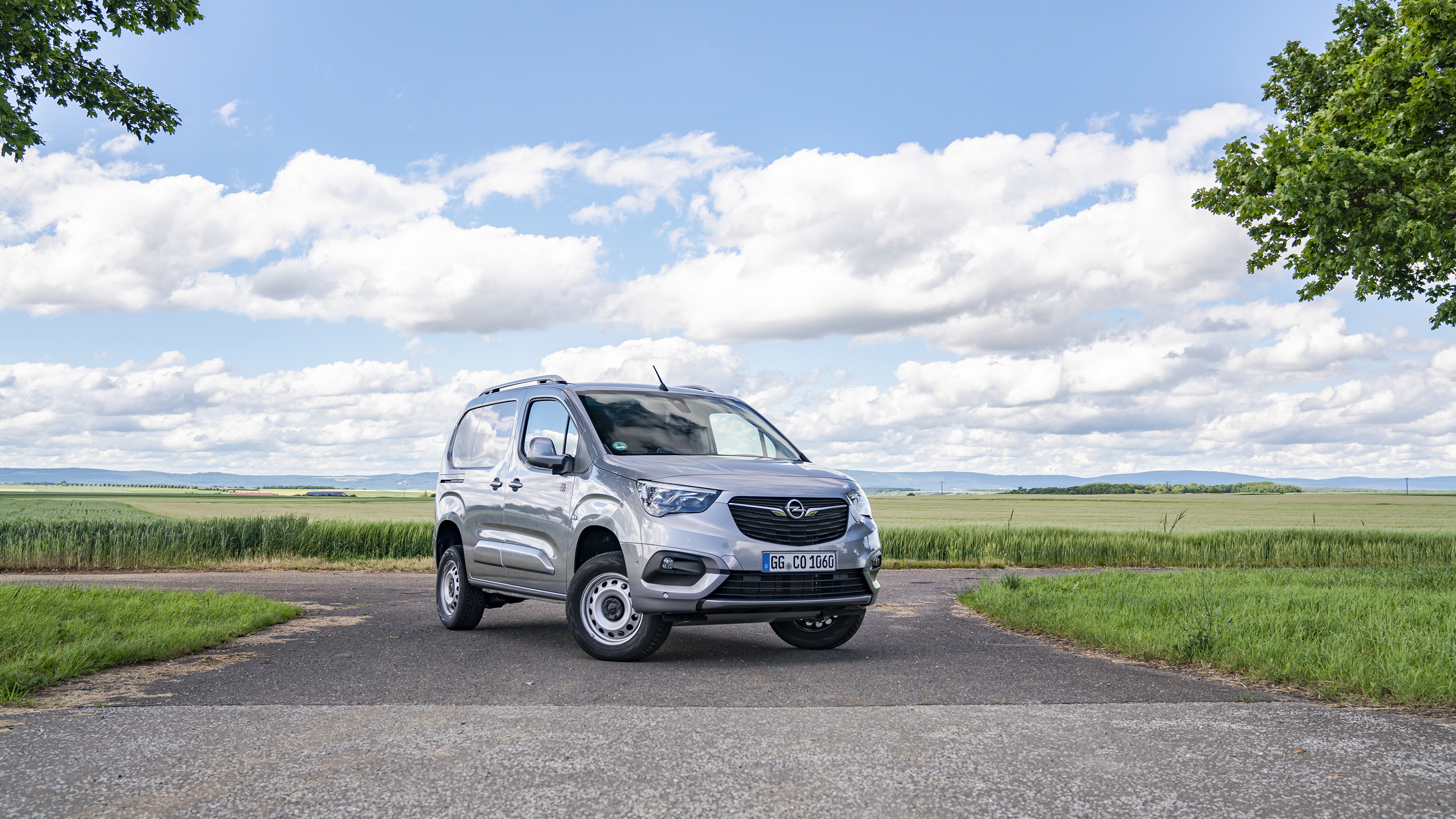 Grey Opel Minivan parked on a road with fields HD Wallpaper