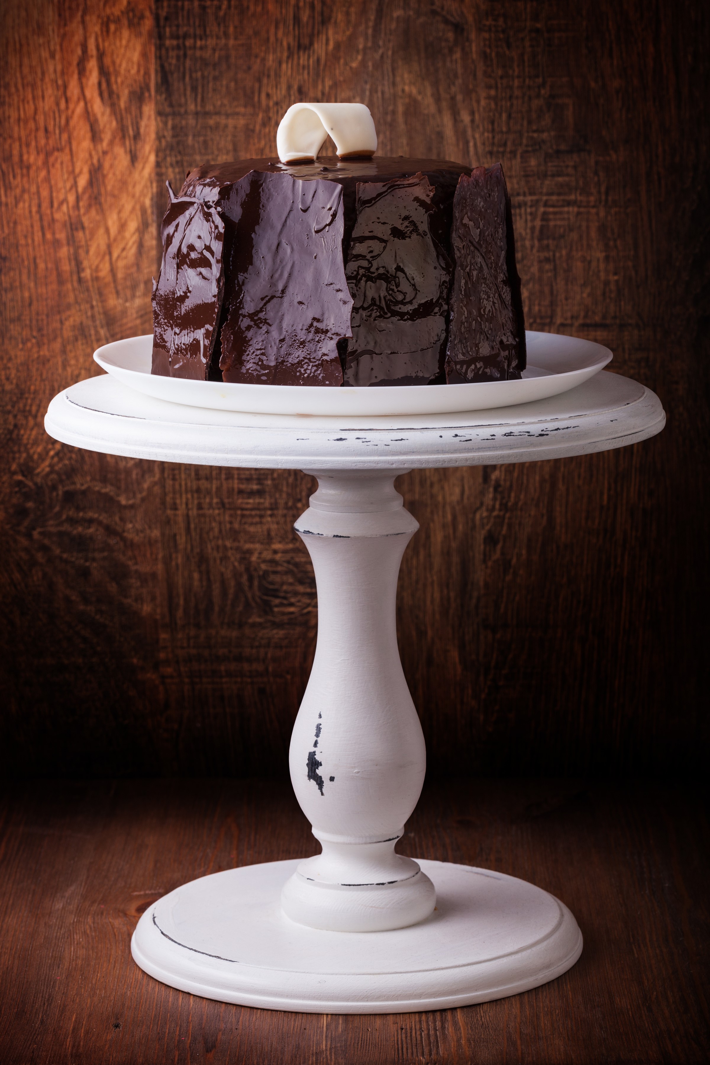 Chocolate cake with white garnish on a cake stand HD Phone Wallpaper