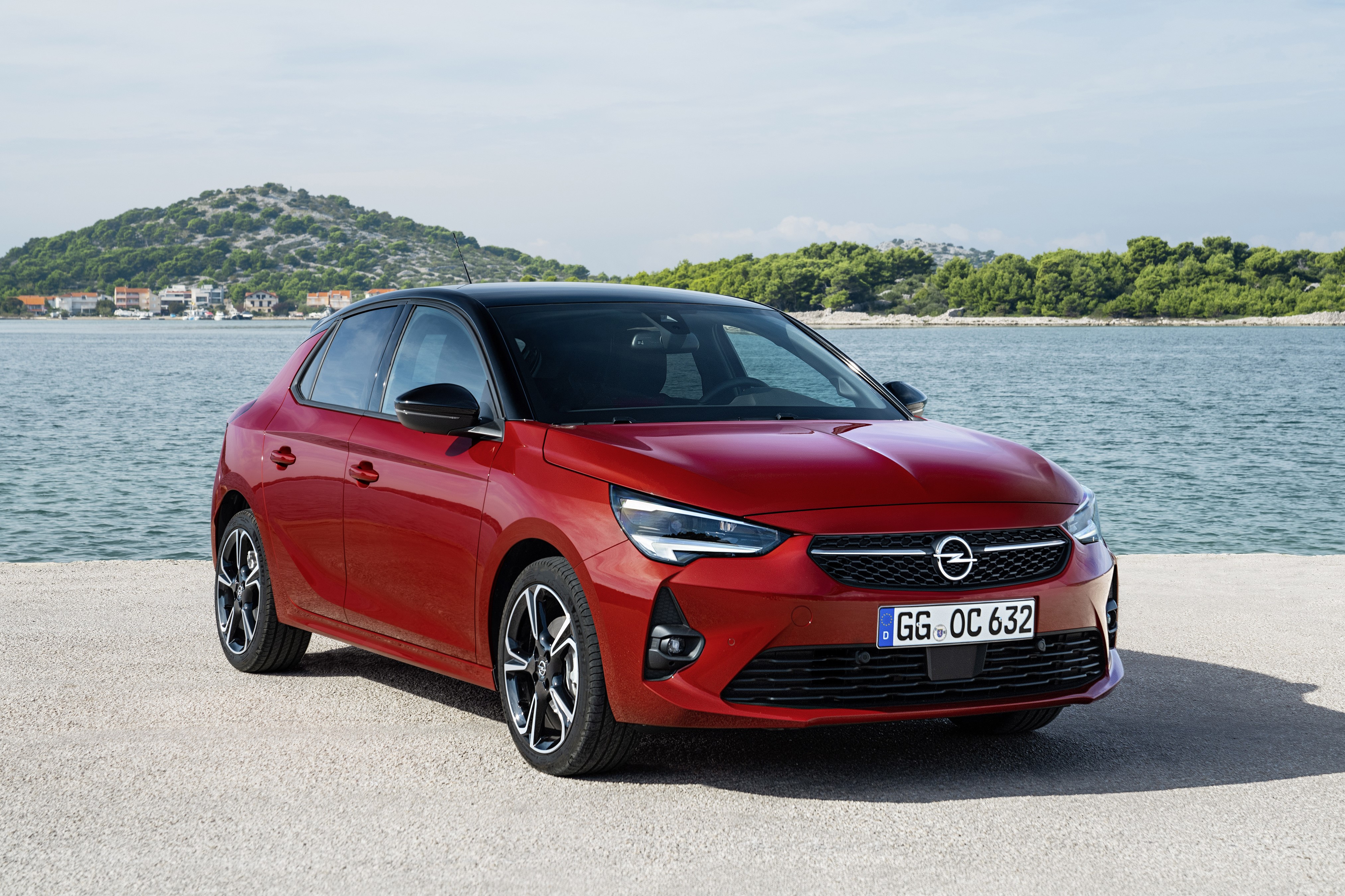 Red Opel Corsa GS Line parked by the sea HD Wallpaper
