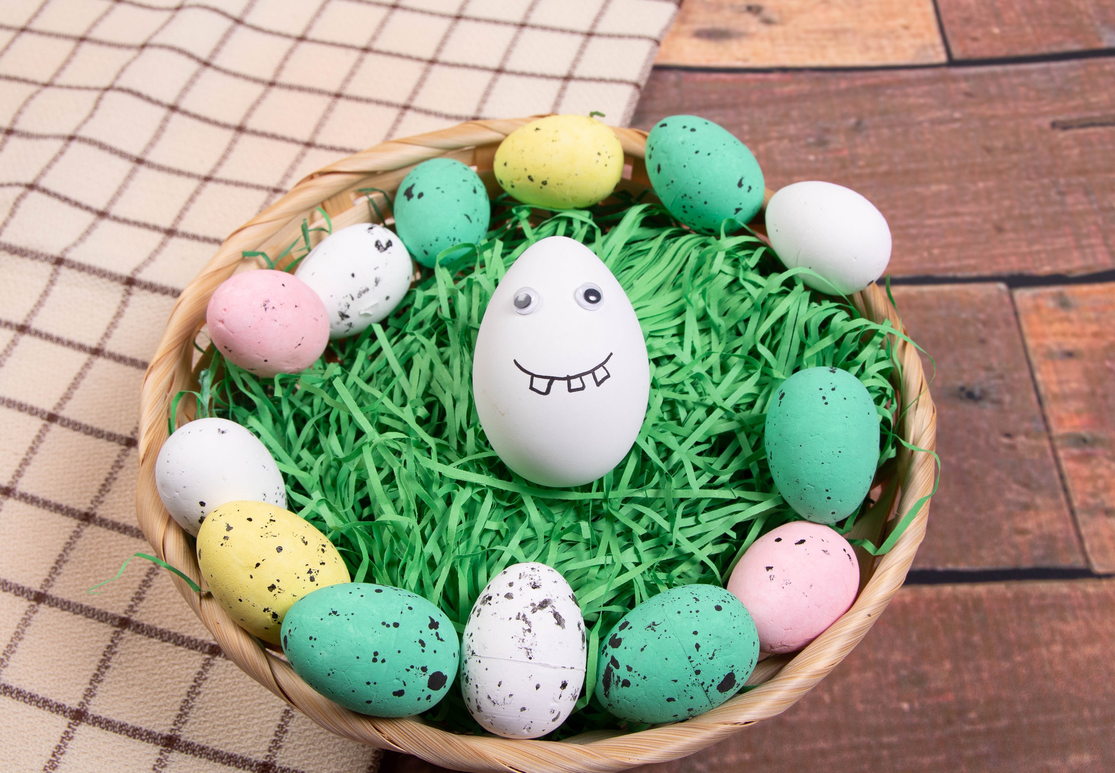 Easter eggs in a wicker basket with grass HD Wallpaper