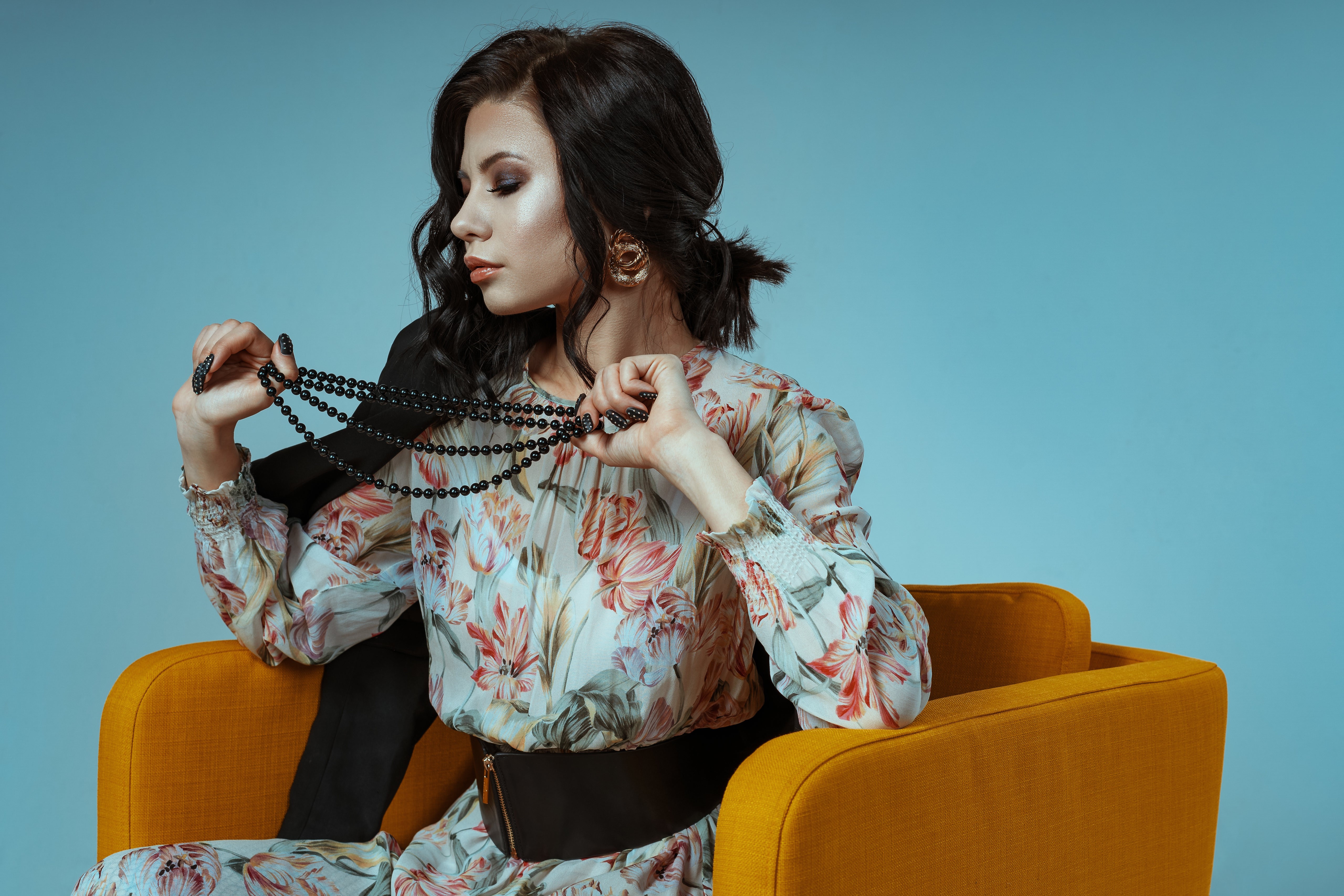 Brunette woman in floral dress with necklace HD Wallpaper