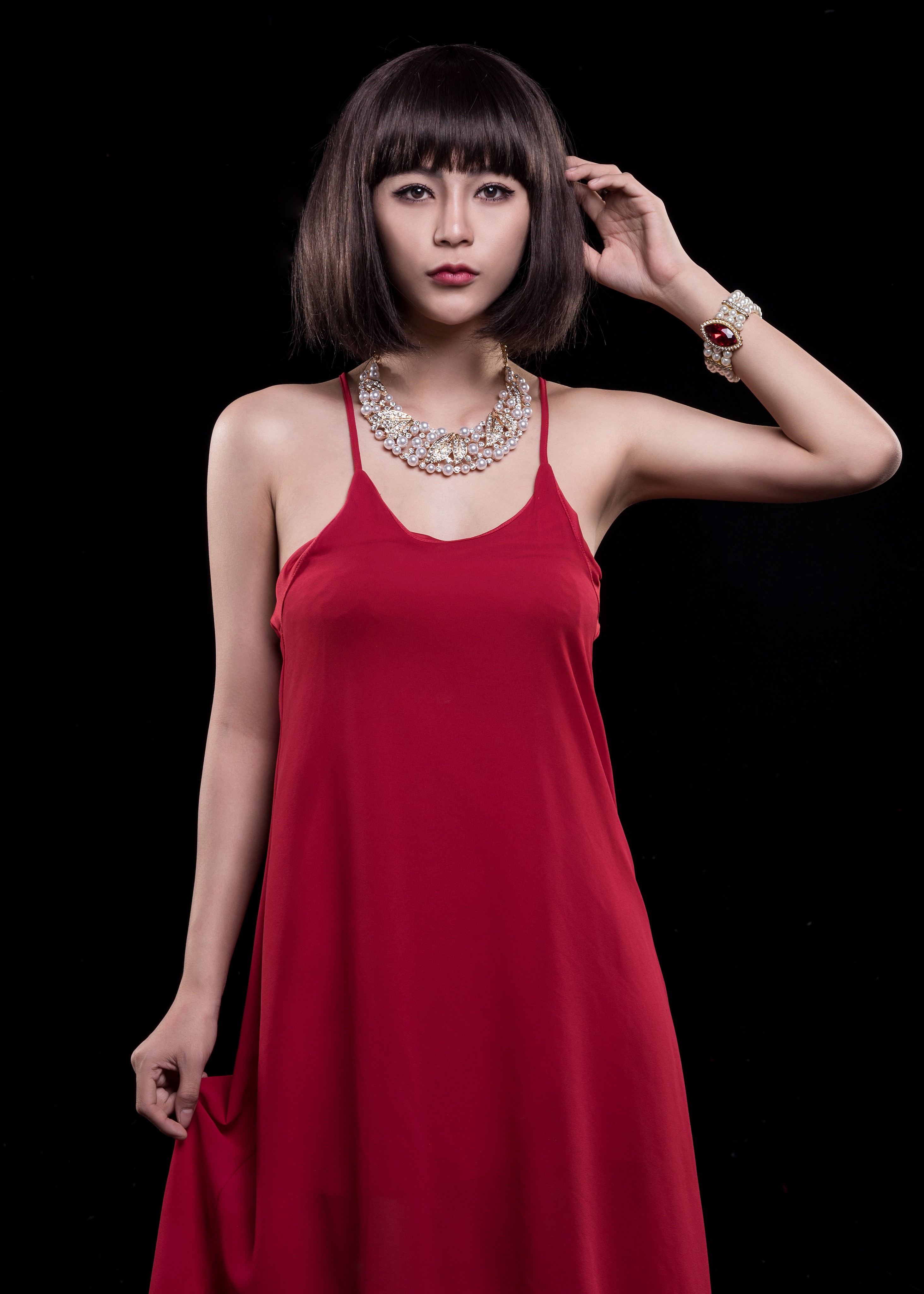 Asian woman in red dress with necklace and bracelet HD Phone Wallpaper