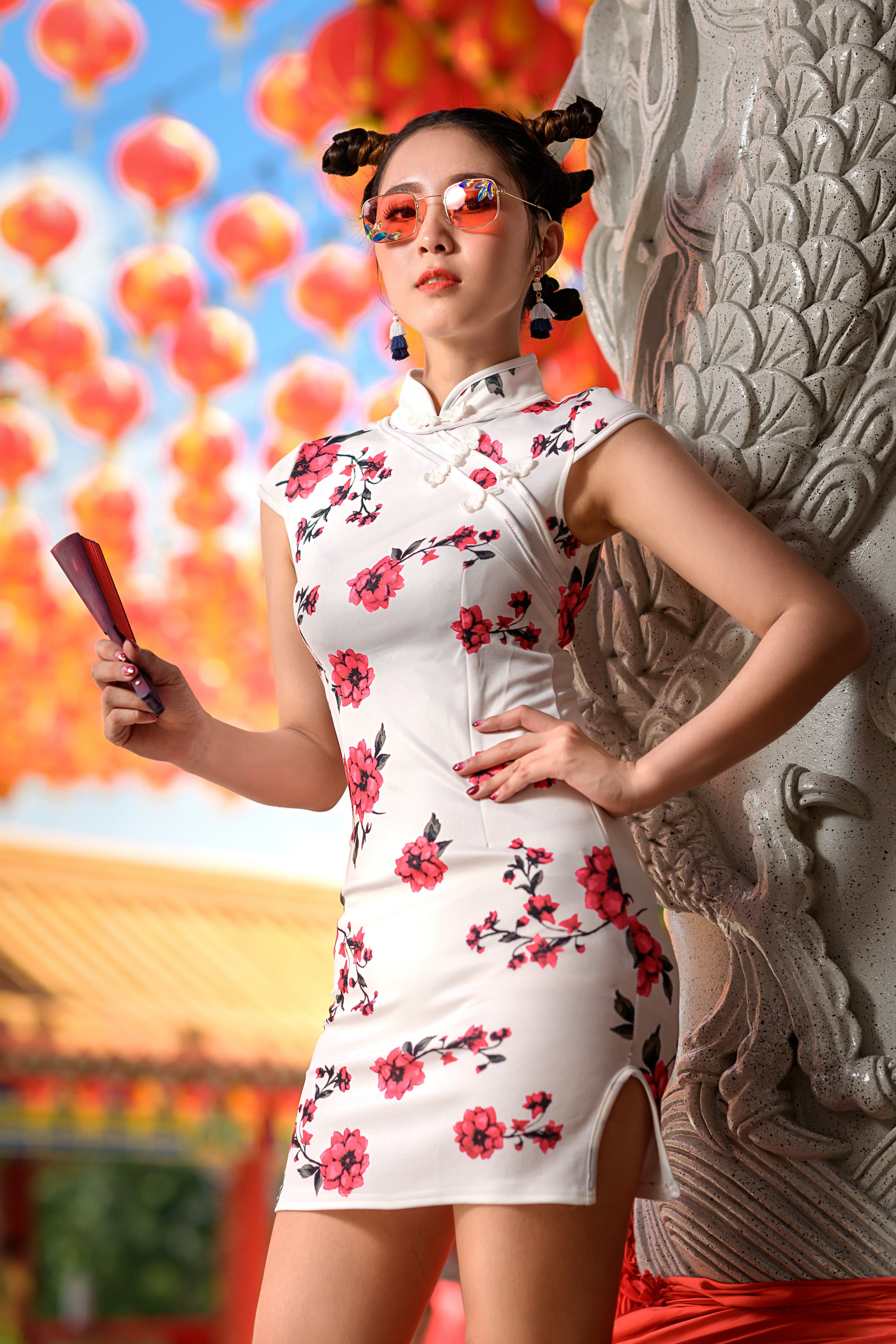 Woman in floral dress holding a fan HD Phone Wallpaper