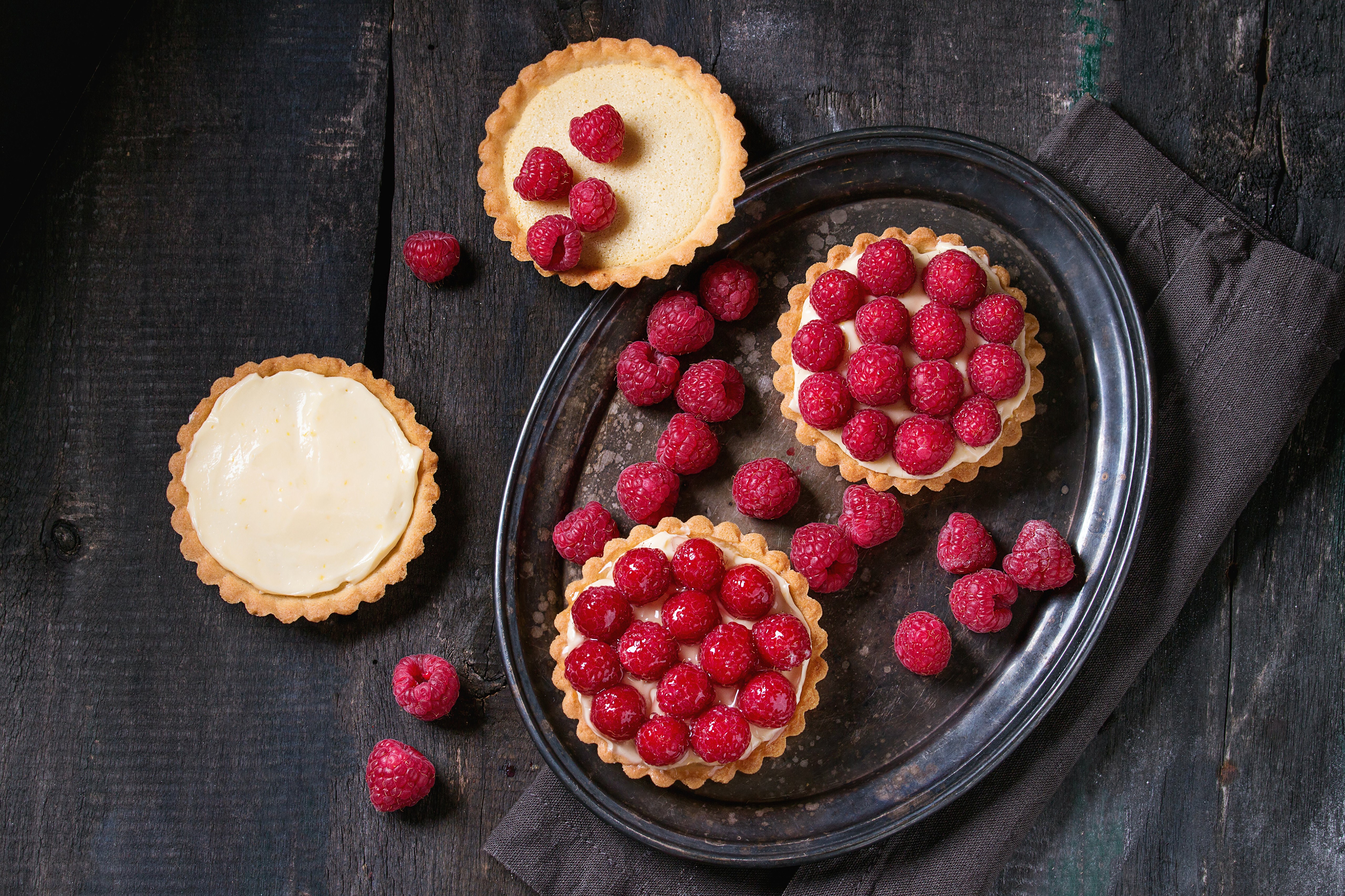 Raspberry tarts on a wooden table HD Wallpaper
