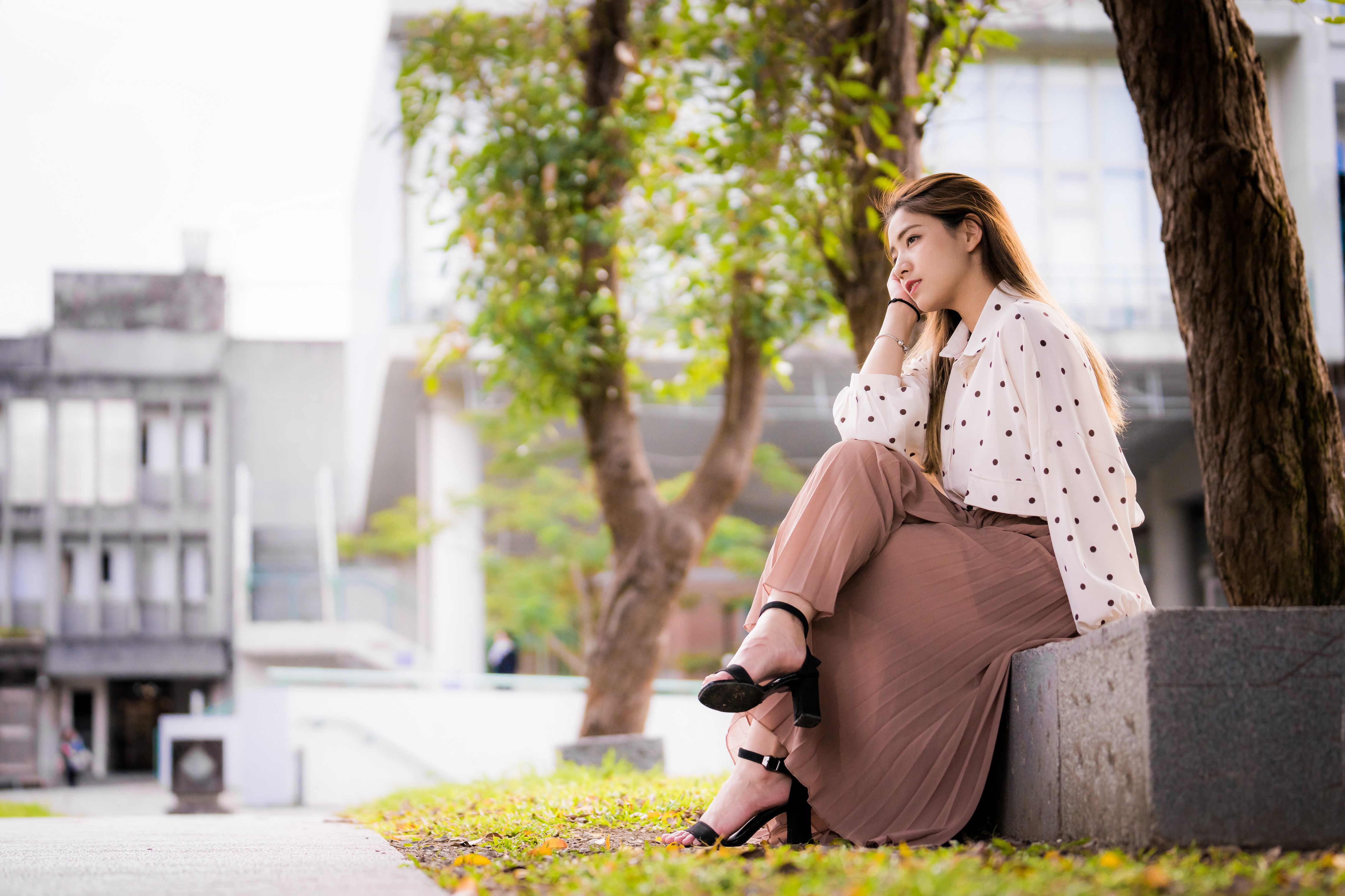 4K Asian Woman Sitting Outdoors in Skirt and Blouse HD Wallpaper
