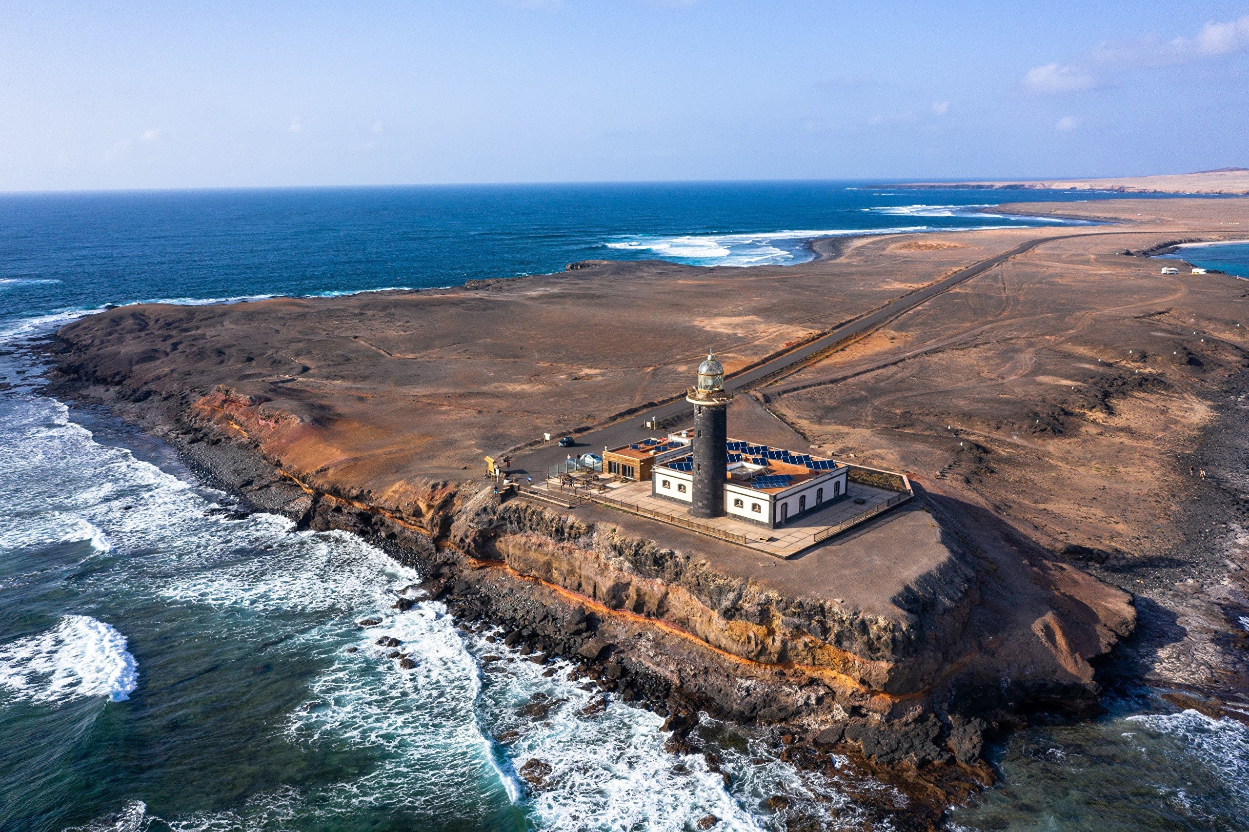 Lighthouse on a rocky coast in the Canary Islands, Spain HD Wallpaper