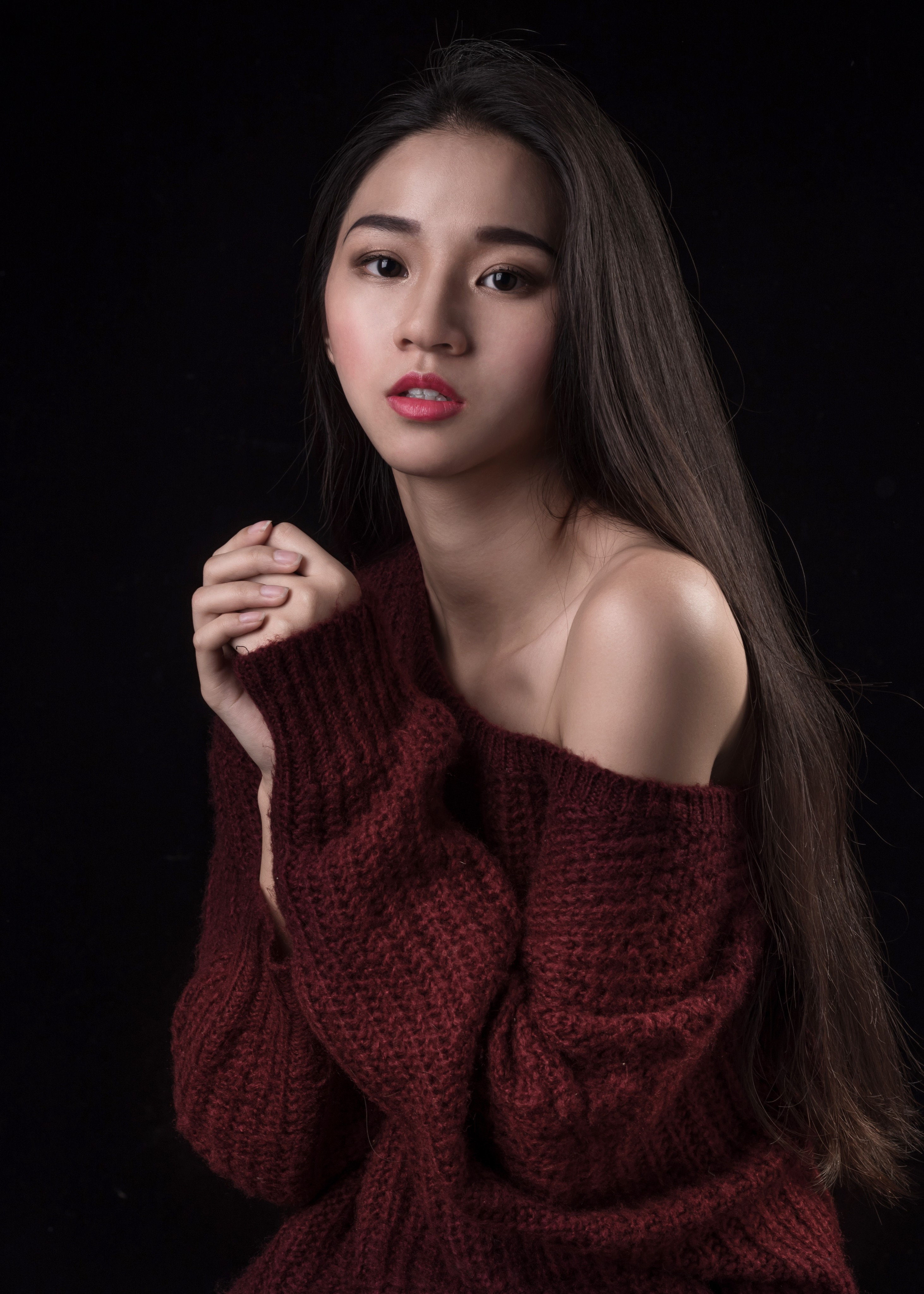Woman in a maroon sweater with long hair HD Phone Wallpaper