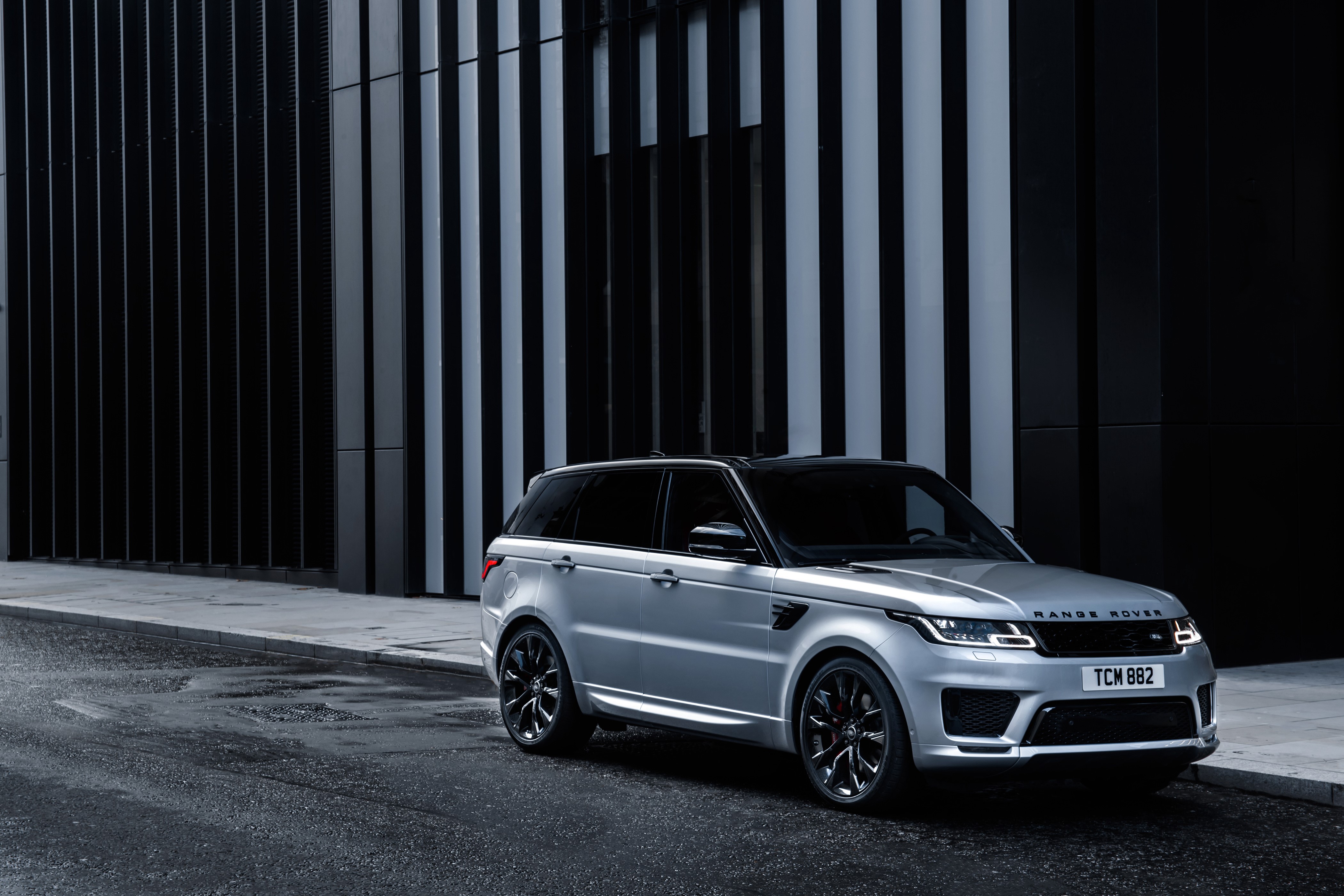Silver Range Rover Sport HST parked on wet street HD Wallpaper