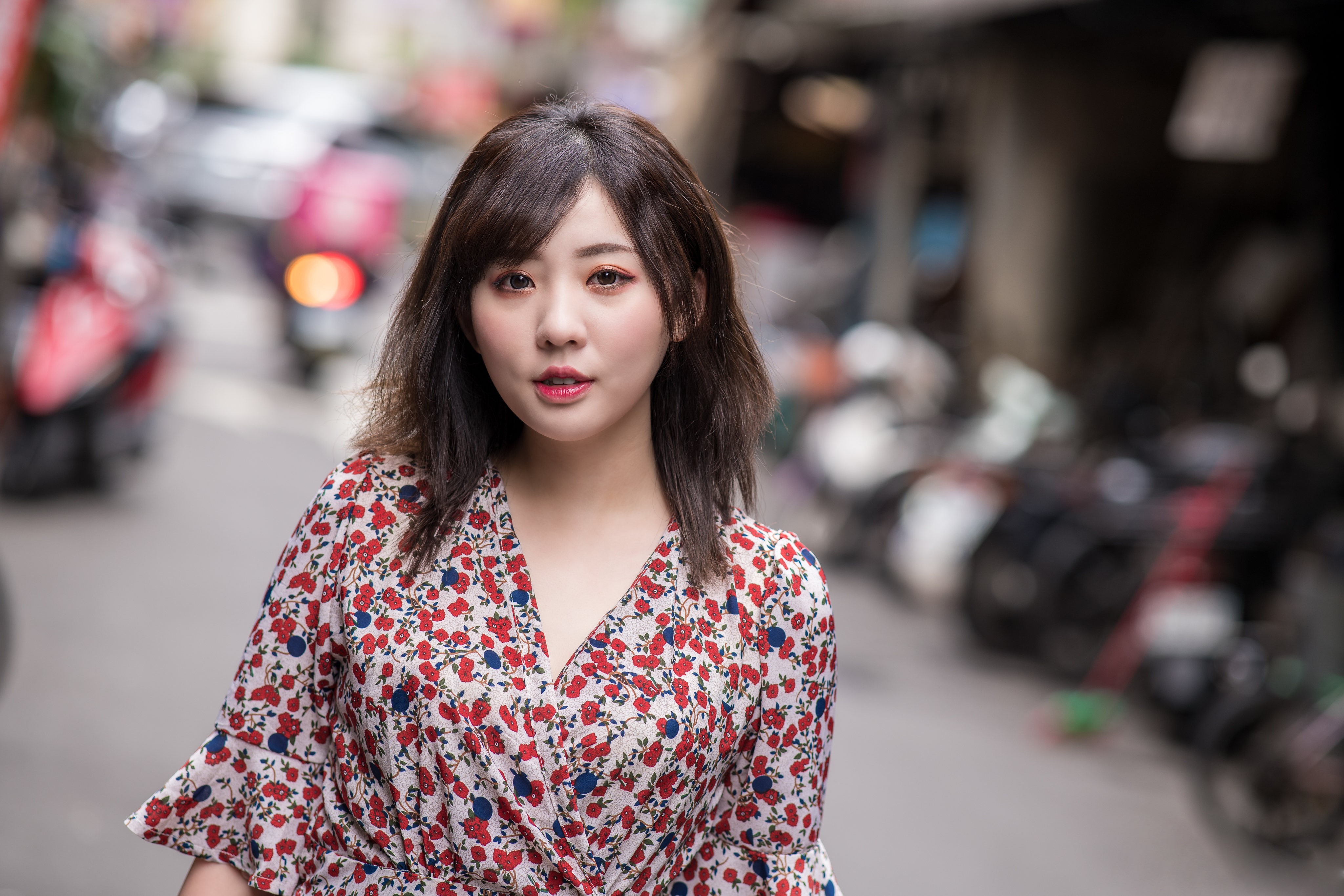 Asian woman in floral dress on street HD Wallpaper