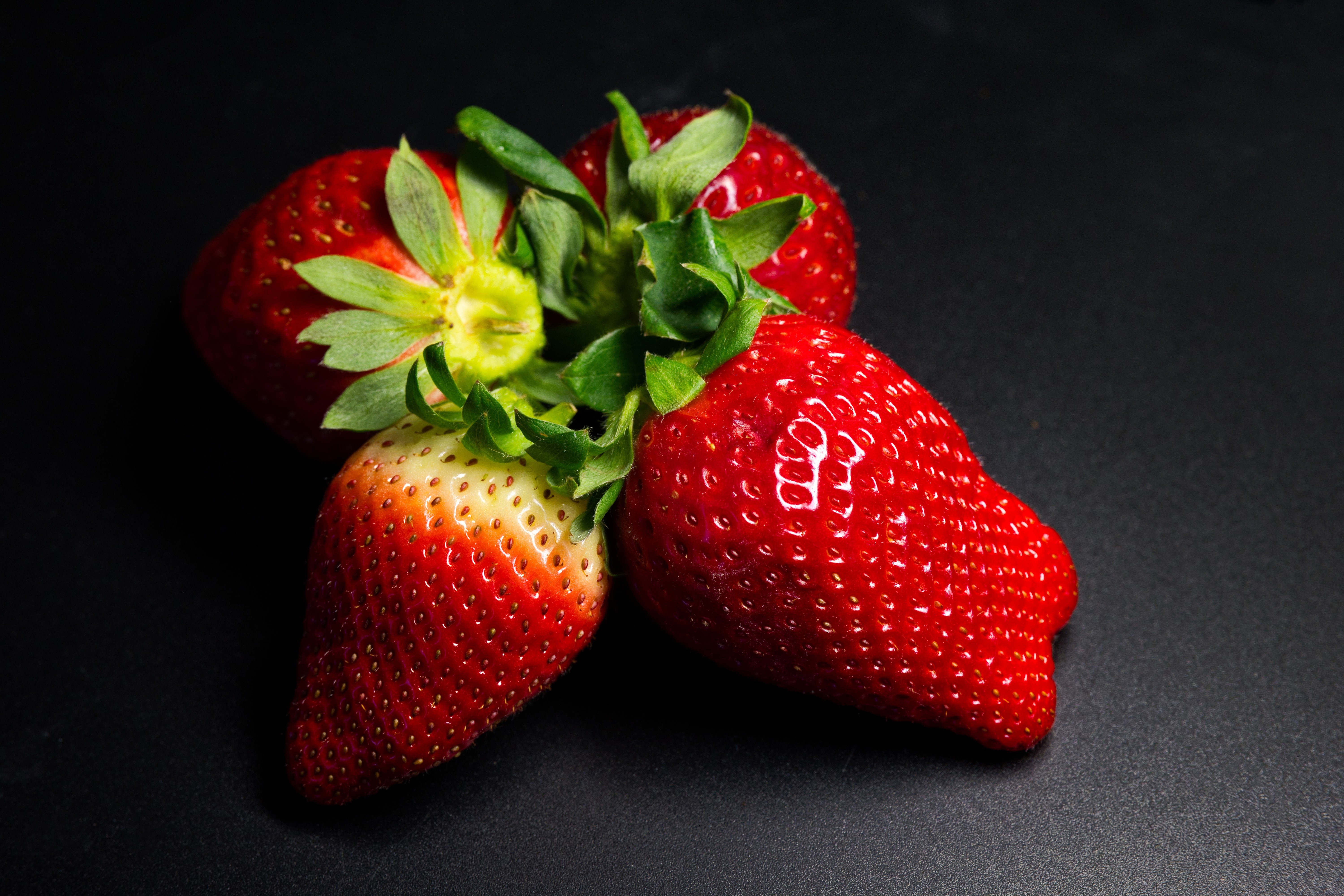Four Strawberries on a Dark Background HD Wallpaper