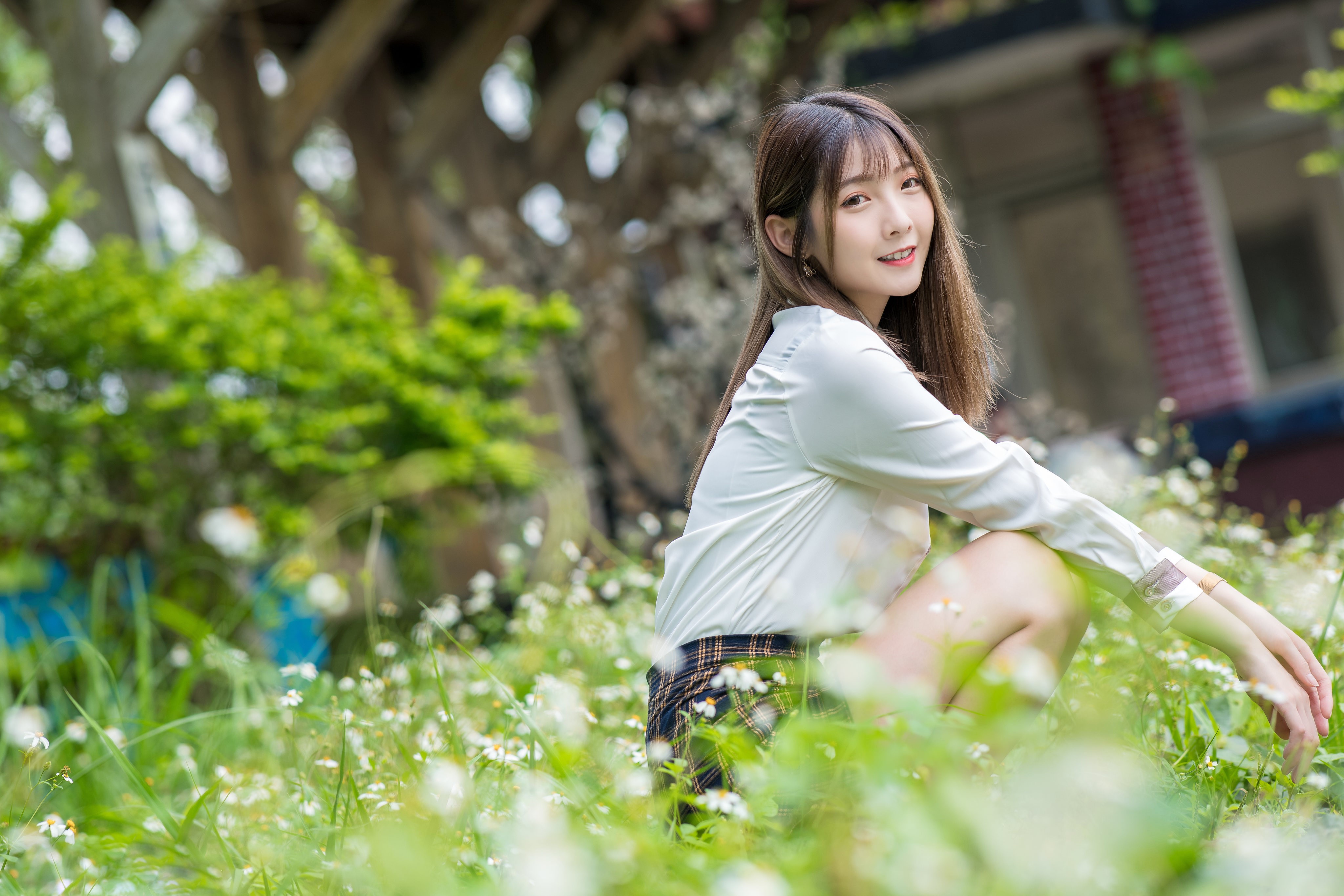 Asian girl sitting in grass and flowers HD Wallpaper