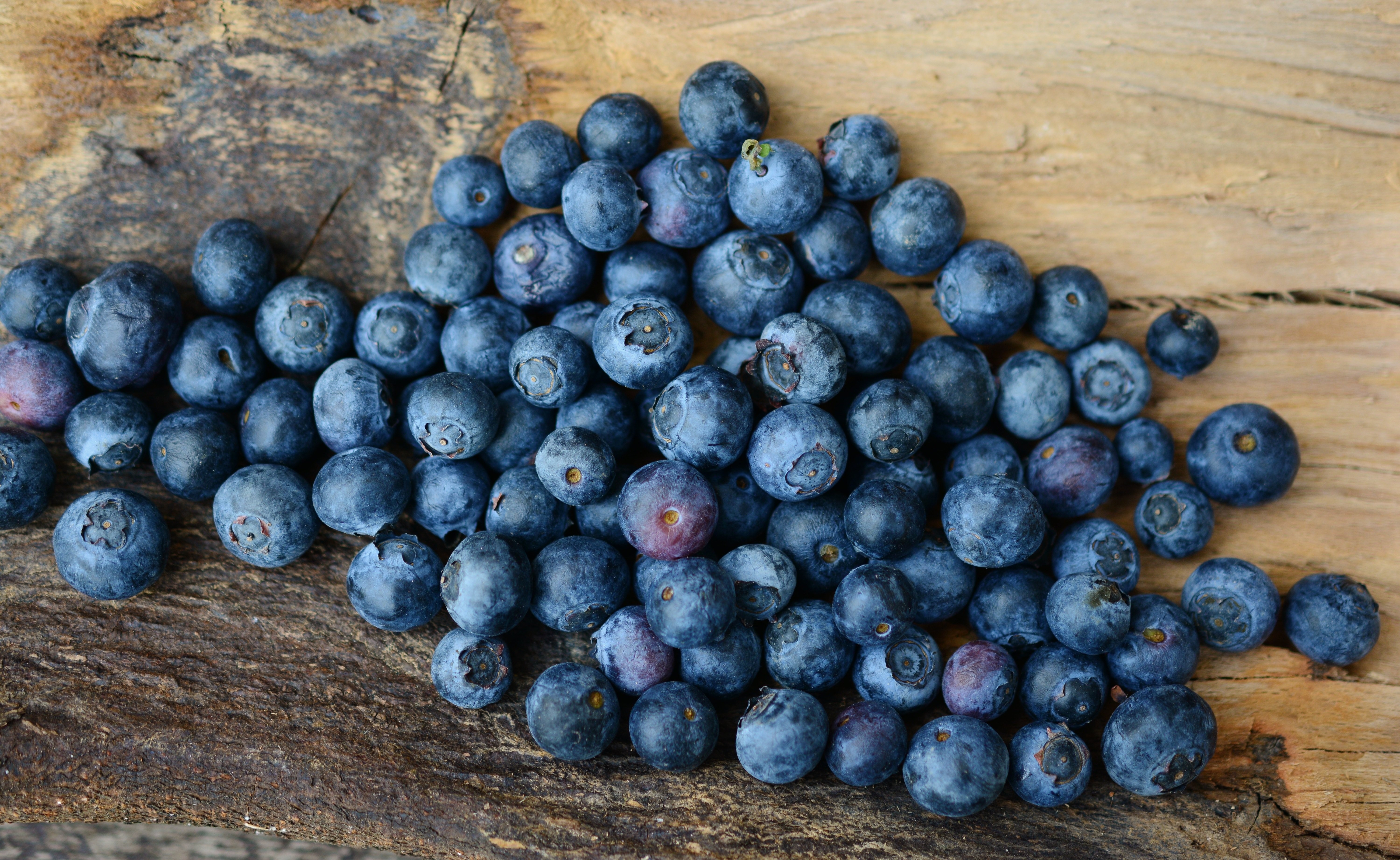 Blueberries on a wooden surface HD Wallpaper
