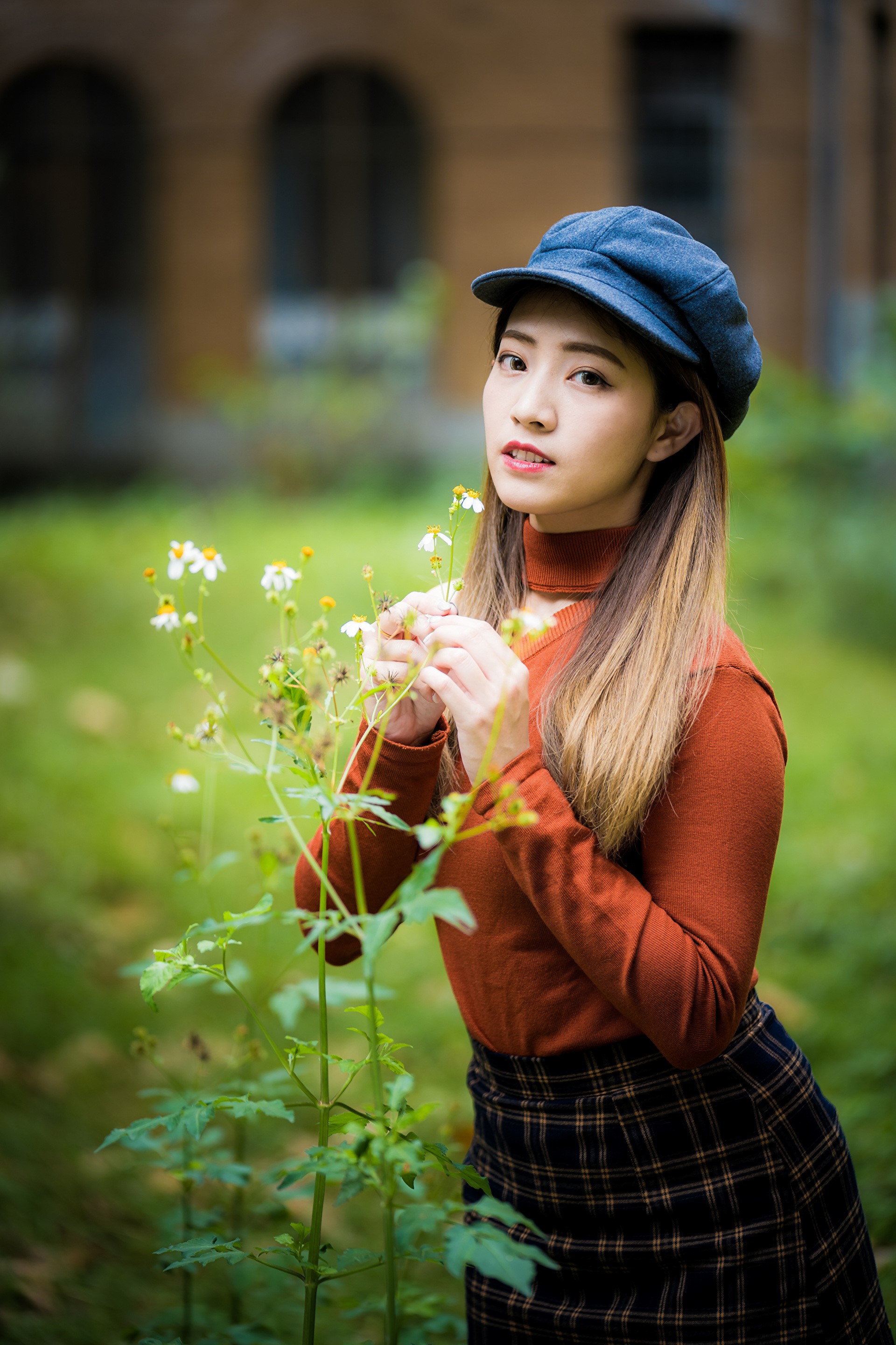 Asian woman in sweater and hat near flowers HD Phone Wallpaper