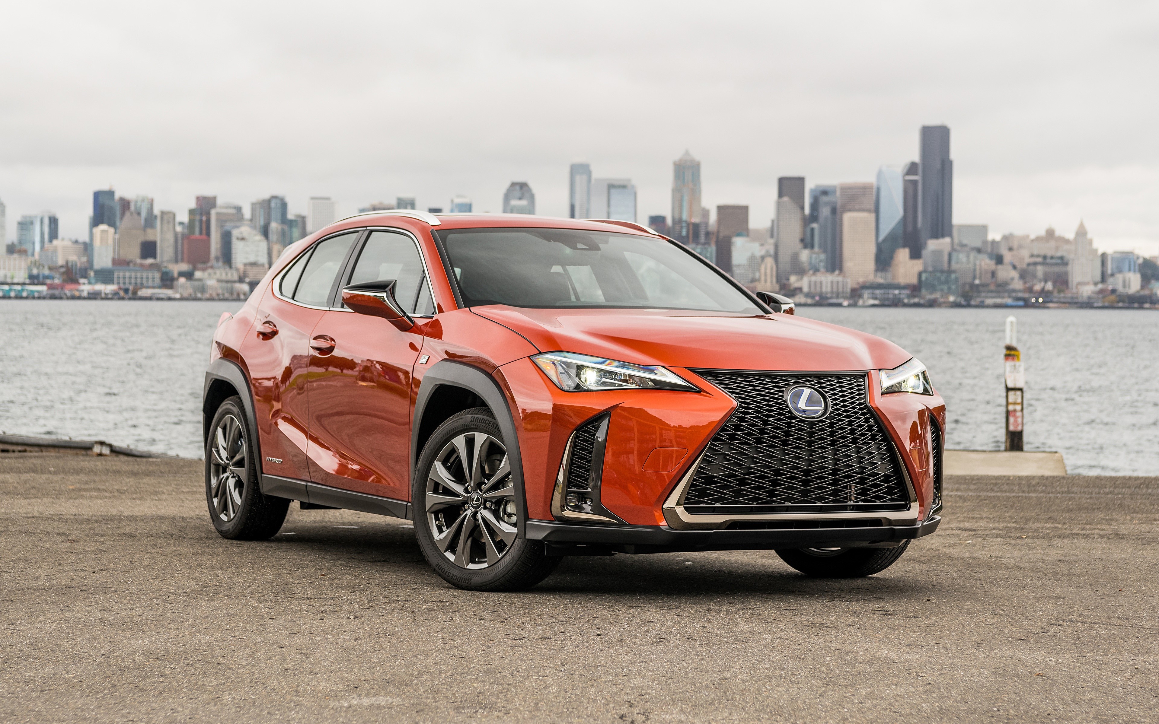 Orange Lexus UX200 Crossover with City Skyline HD Wallpaper