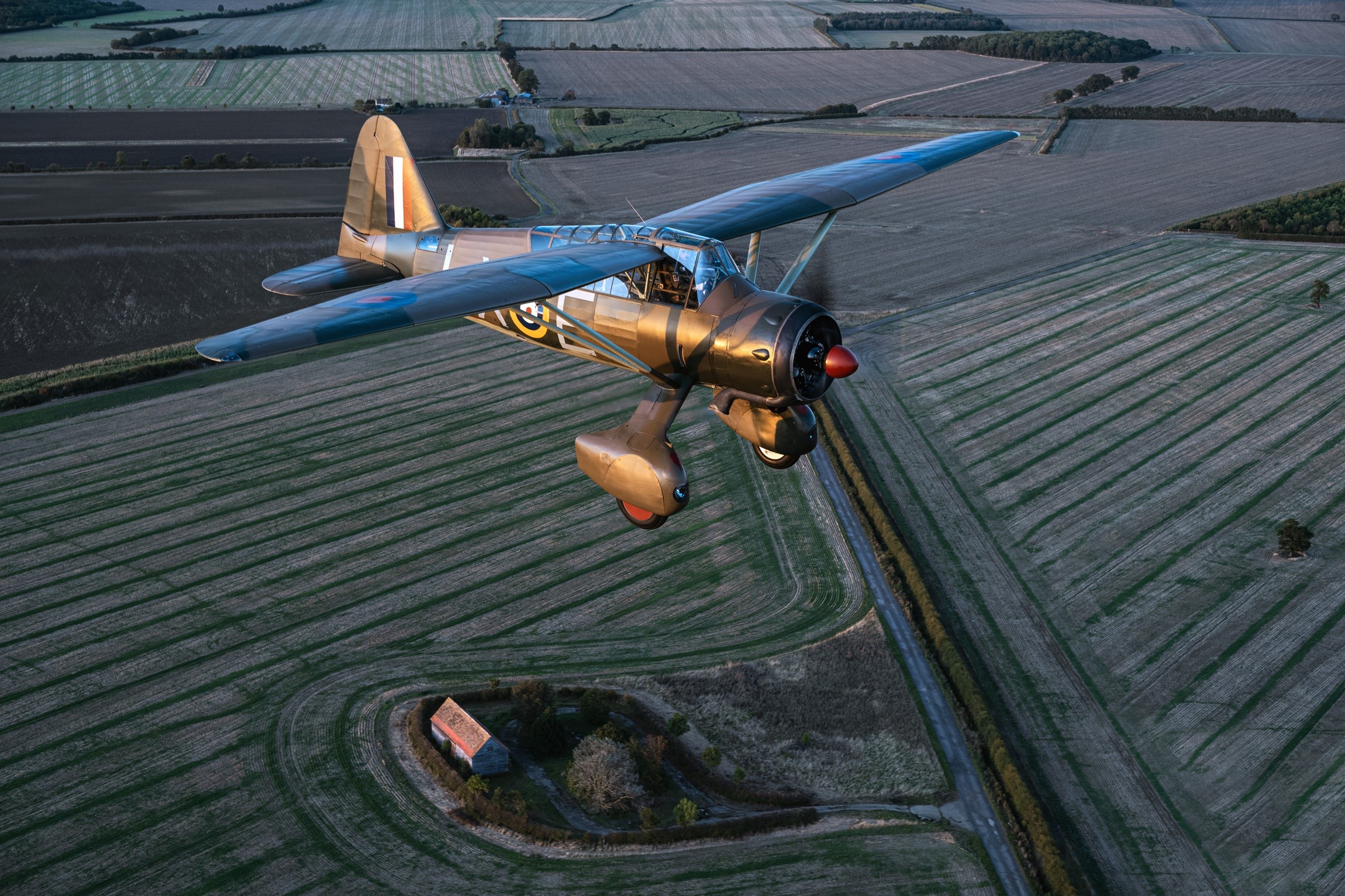 Westland Lysander Mk.IIITT airplane flying over farmland HD Wallpaper