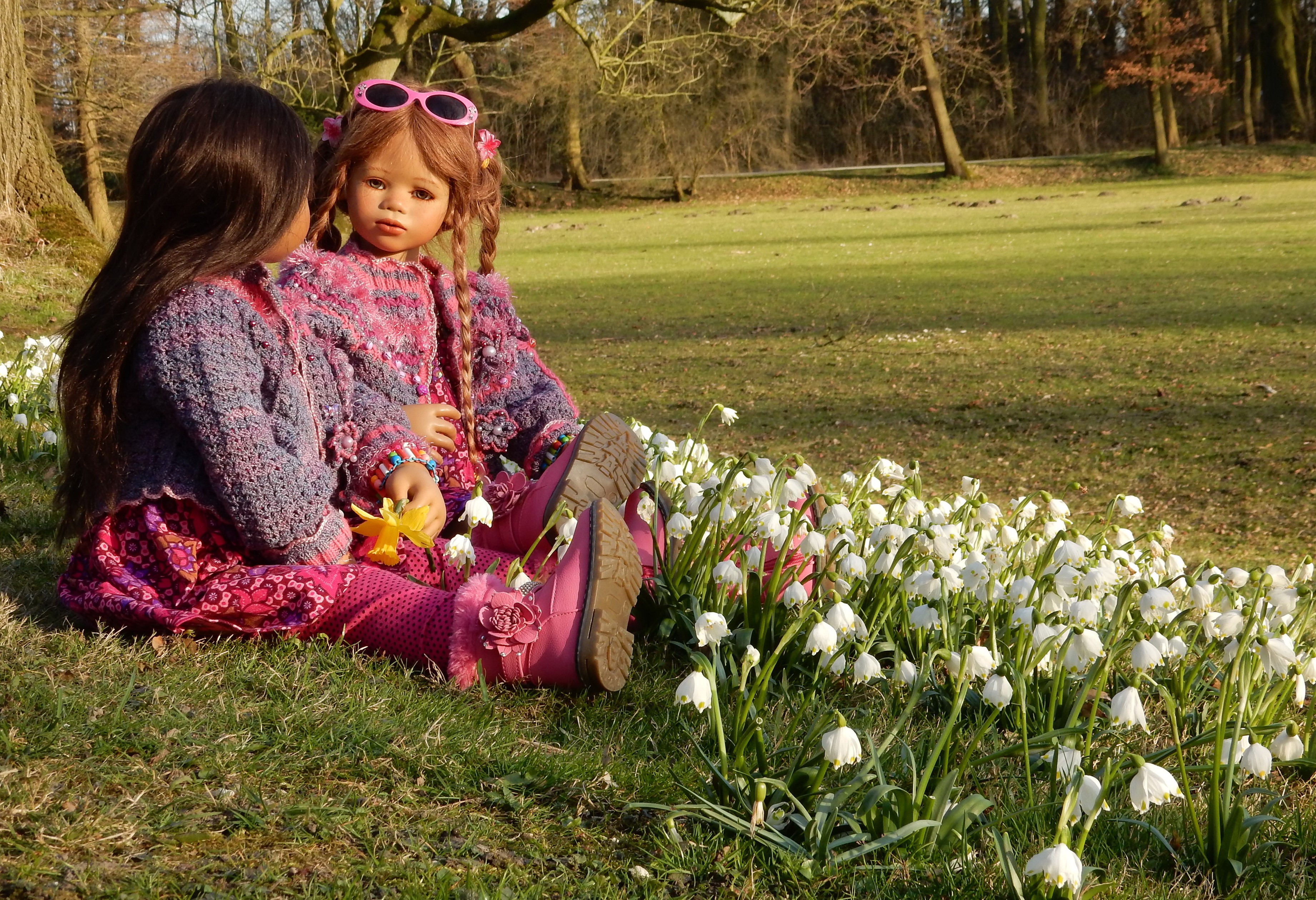 Two dolls in a park with flowers HD Wallpaper