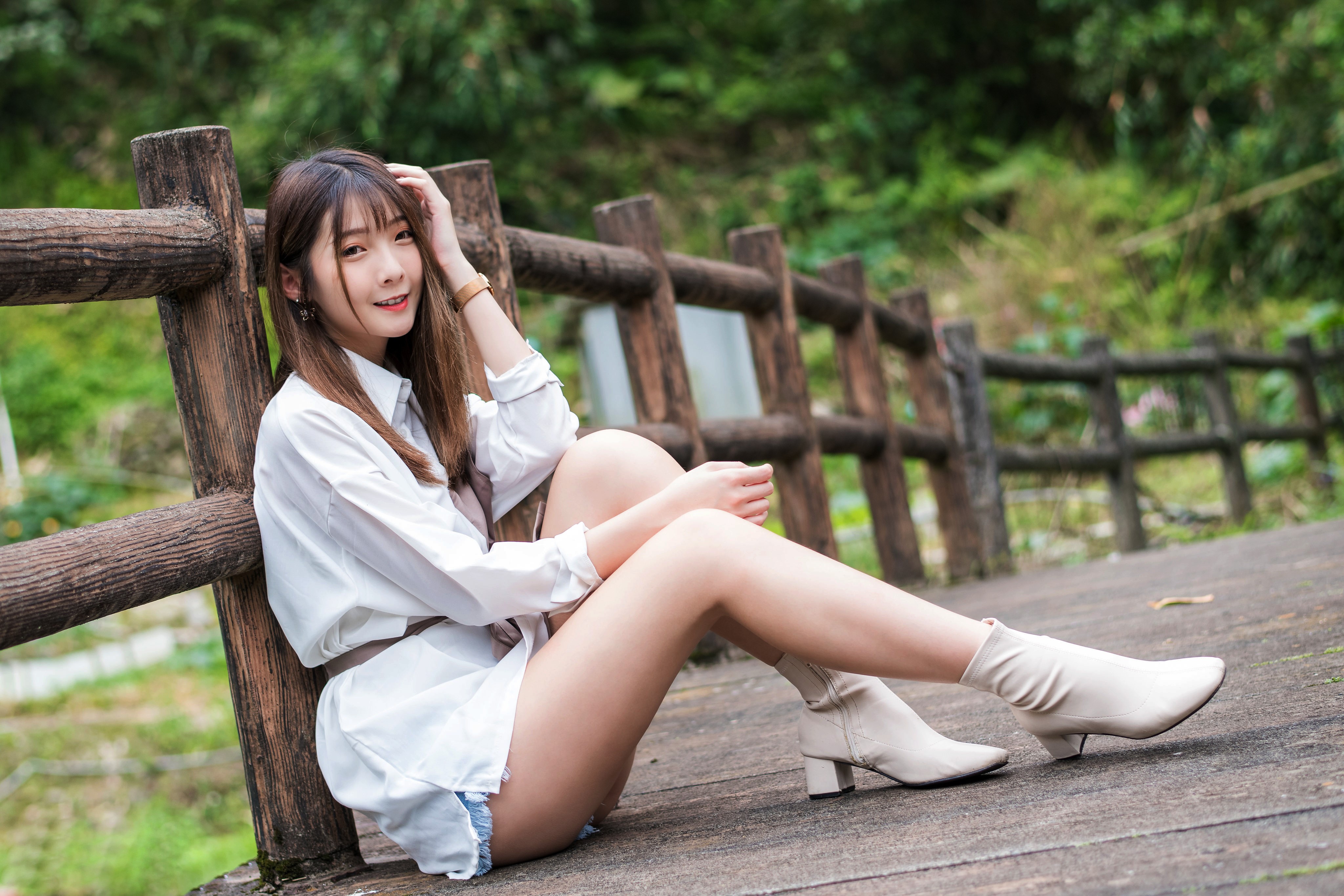 4K Asian Woman Sitting by Wooden Fence HD Wallpaper