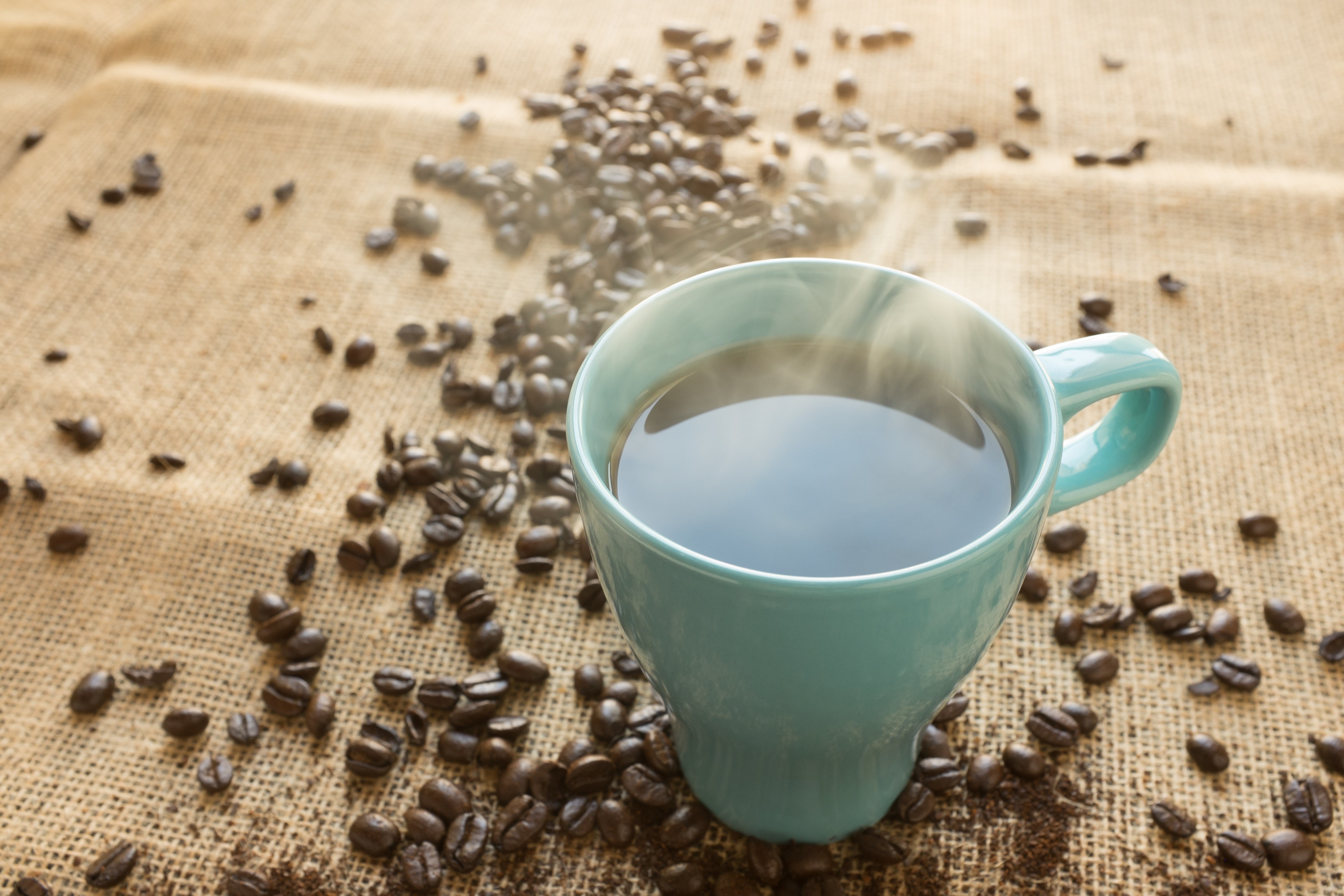Hot Coffee in a Mug with Beans HD Wallpaper