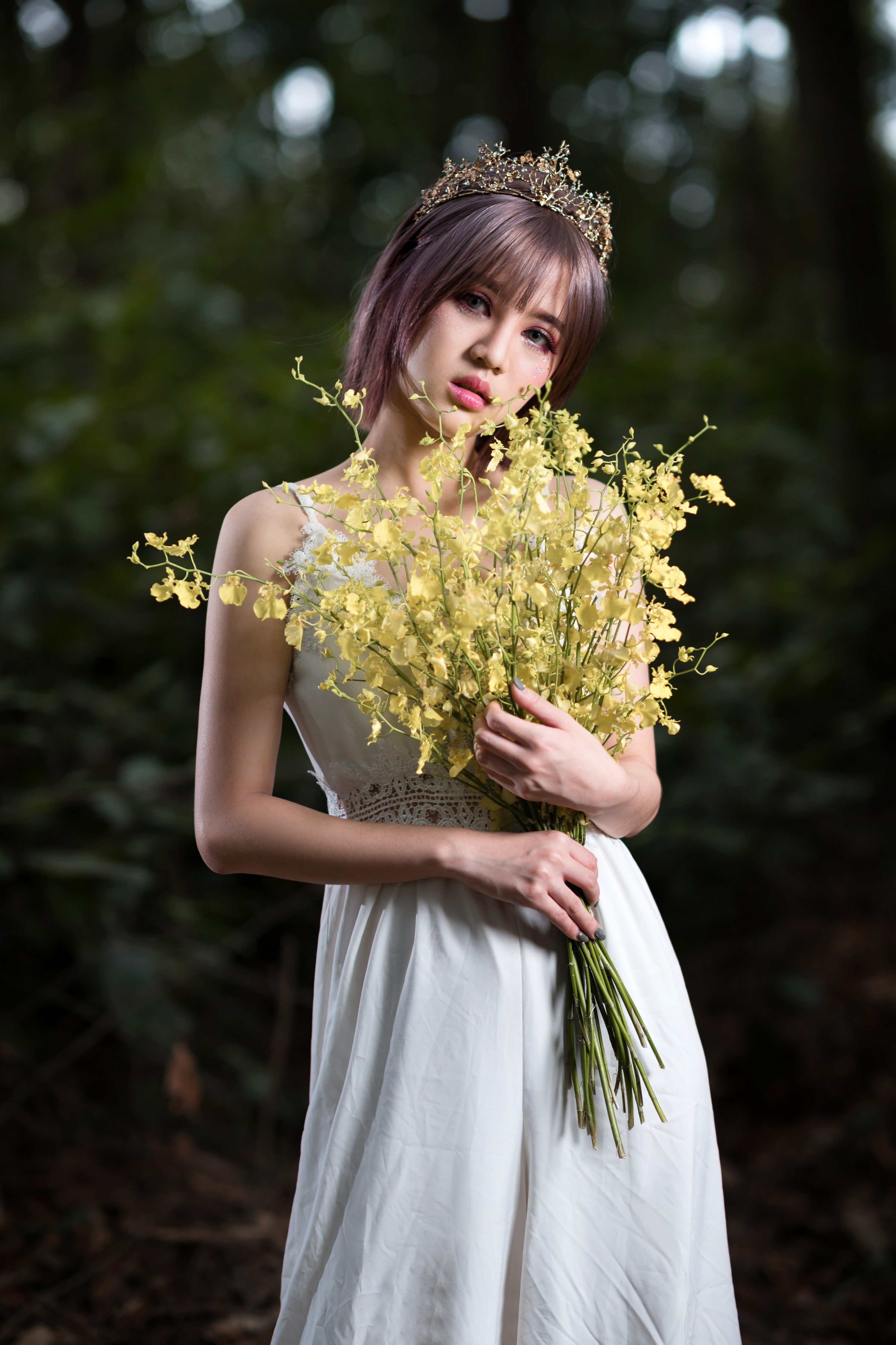 Asian woman with crown holding yellow flowers HD Phone Wallpaper
