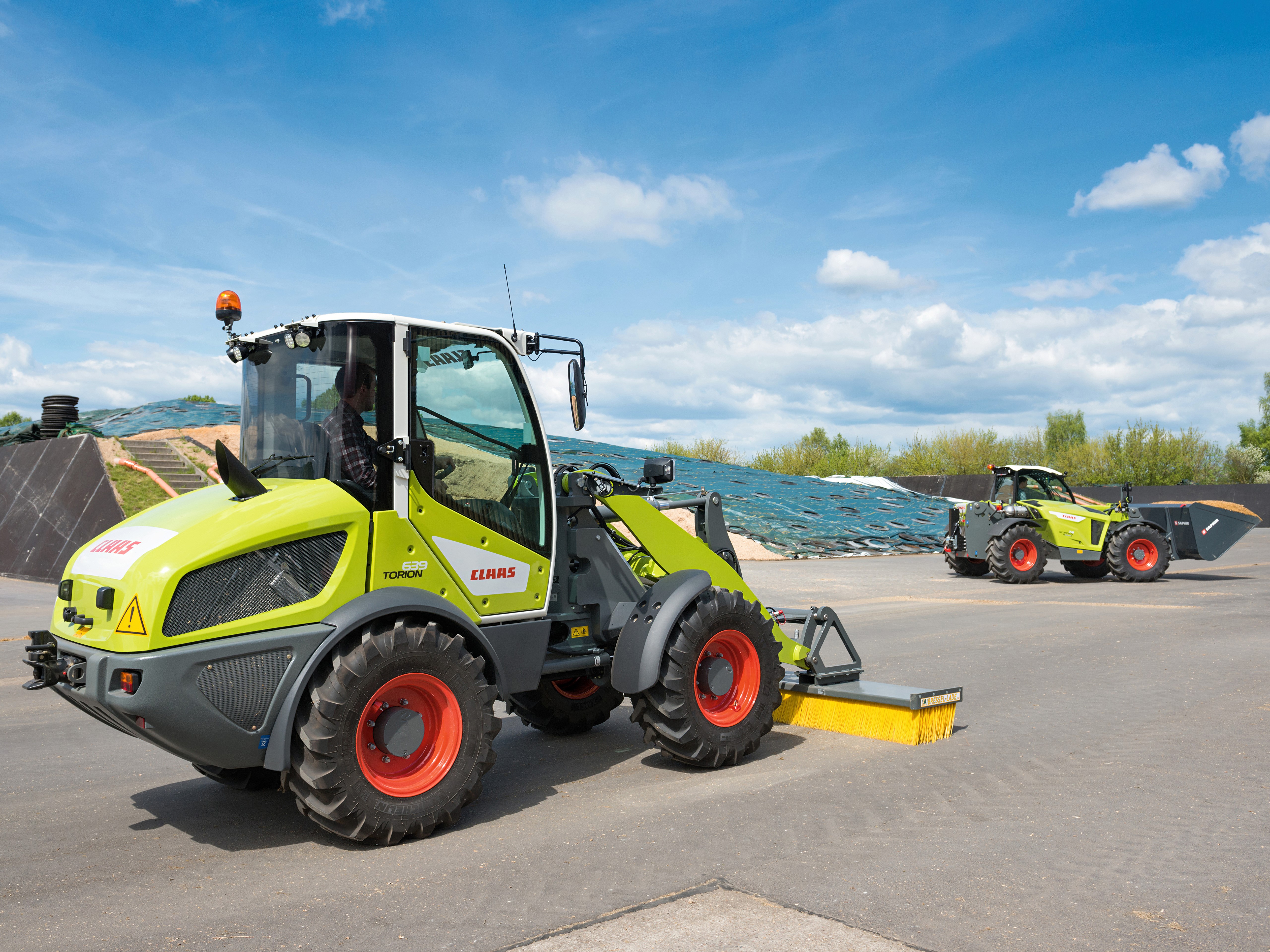 Two Claas Torion wheel loaders with brooms HD Wallpaper