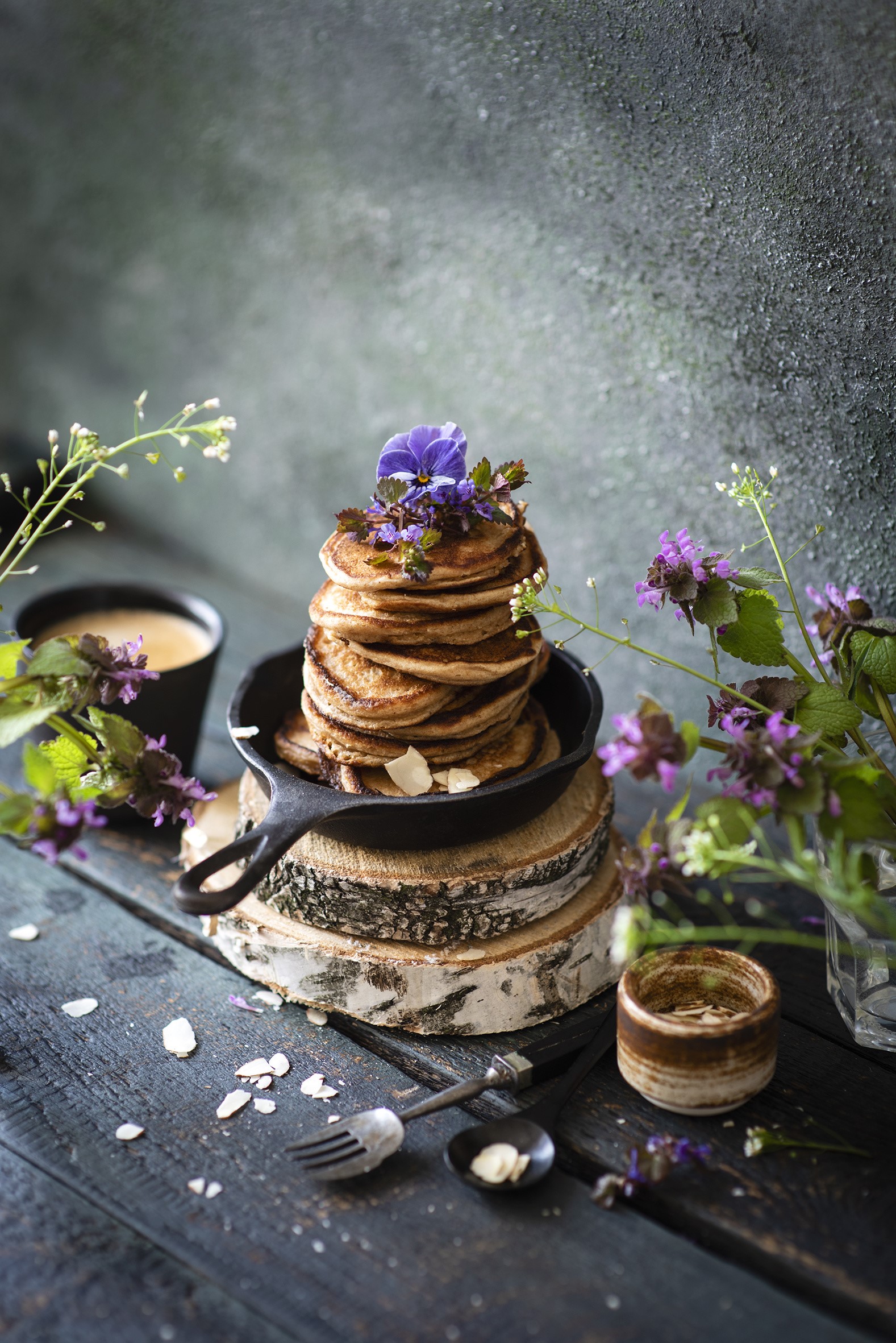 Stack of pancakes in a cast iron pan with flowers HD Phone Wallpaper