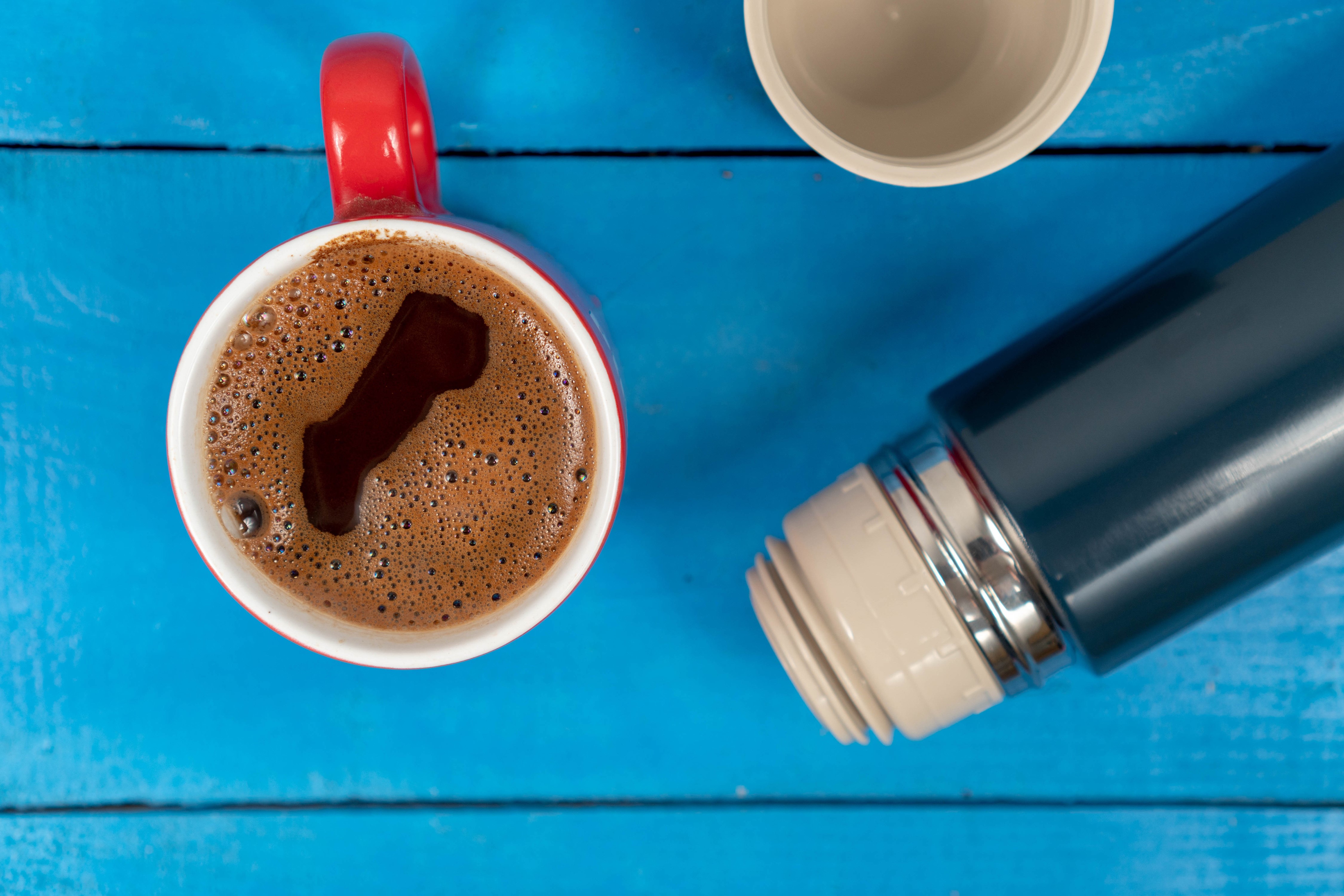 Coffee in a red cup next to a thermos HD Wallpaper
