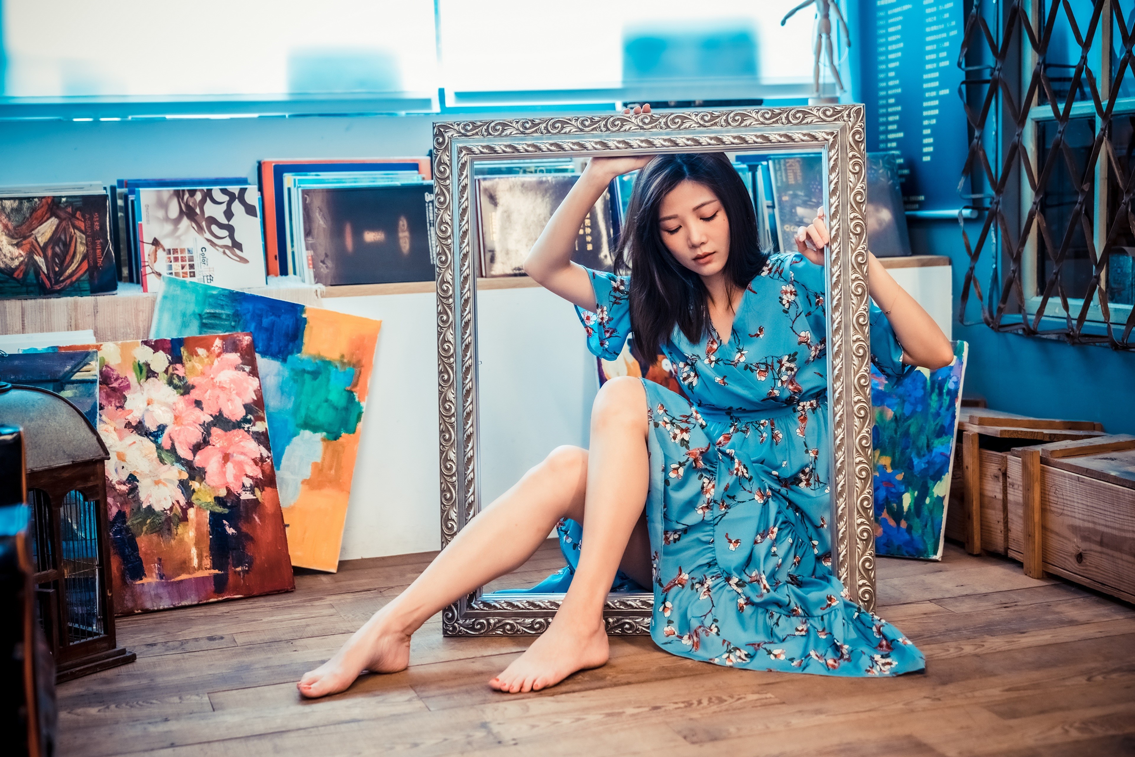Asian woman sitting in a frame with paintings HD Wallpaper