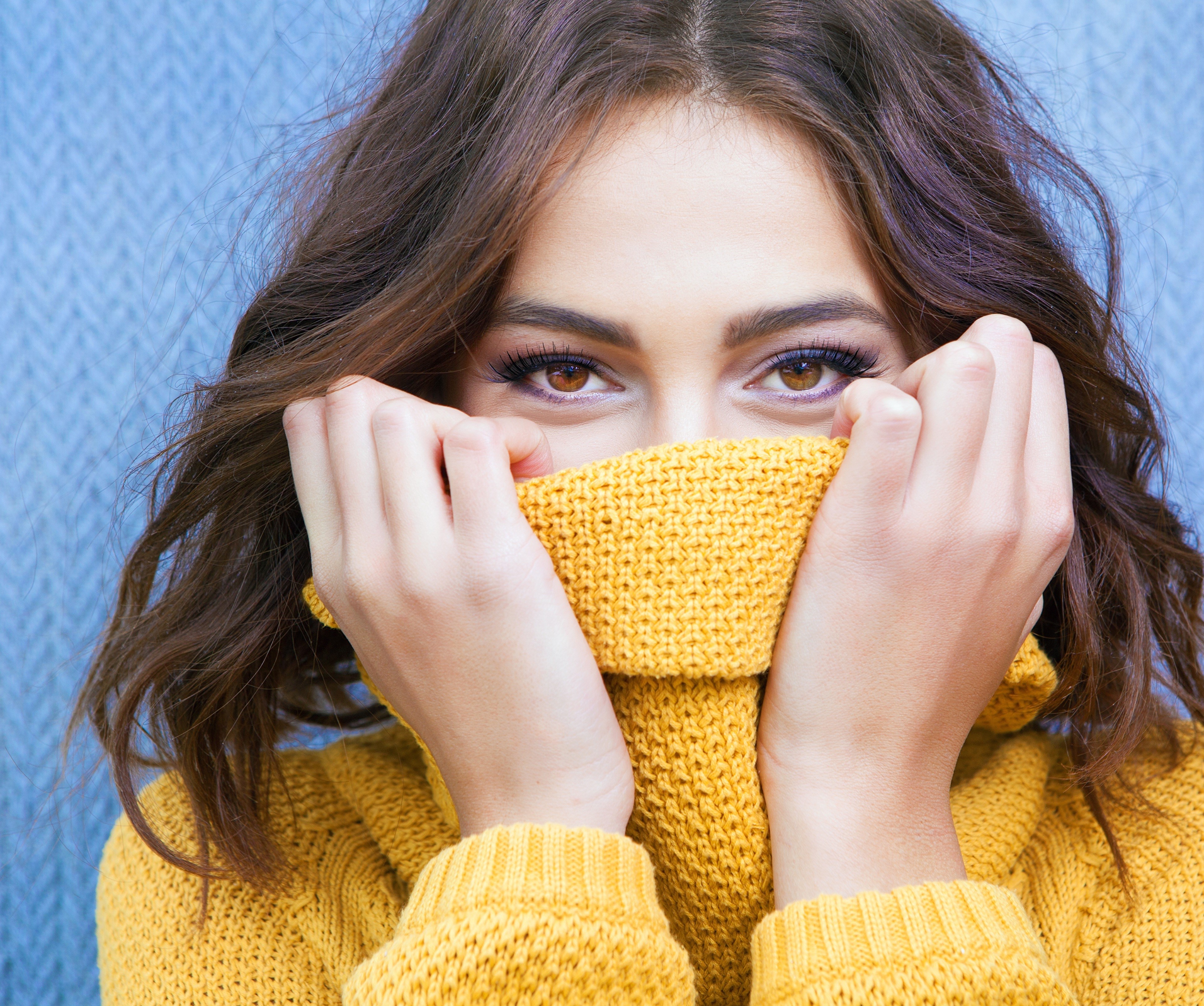 Woman with brown hair wearing a yellow sweater HD Wallpaper