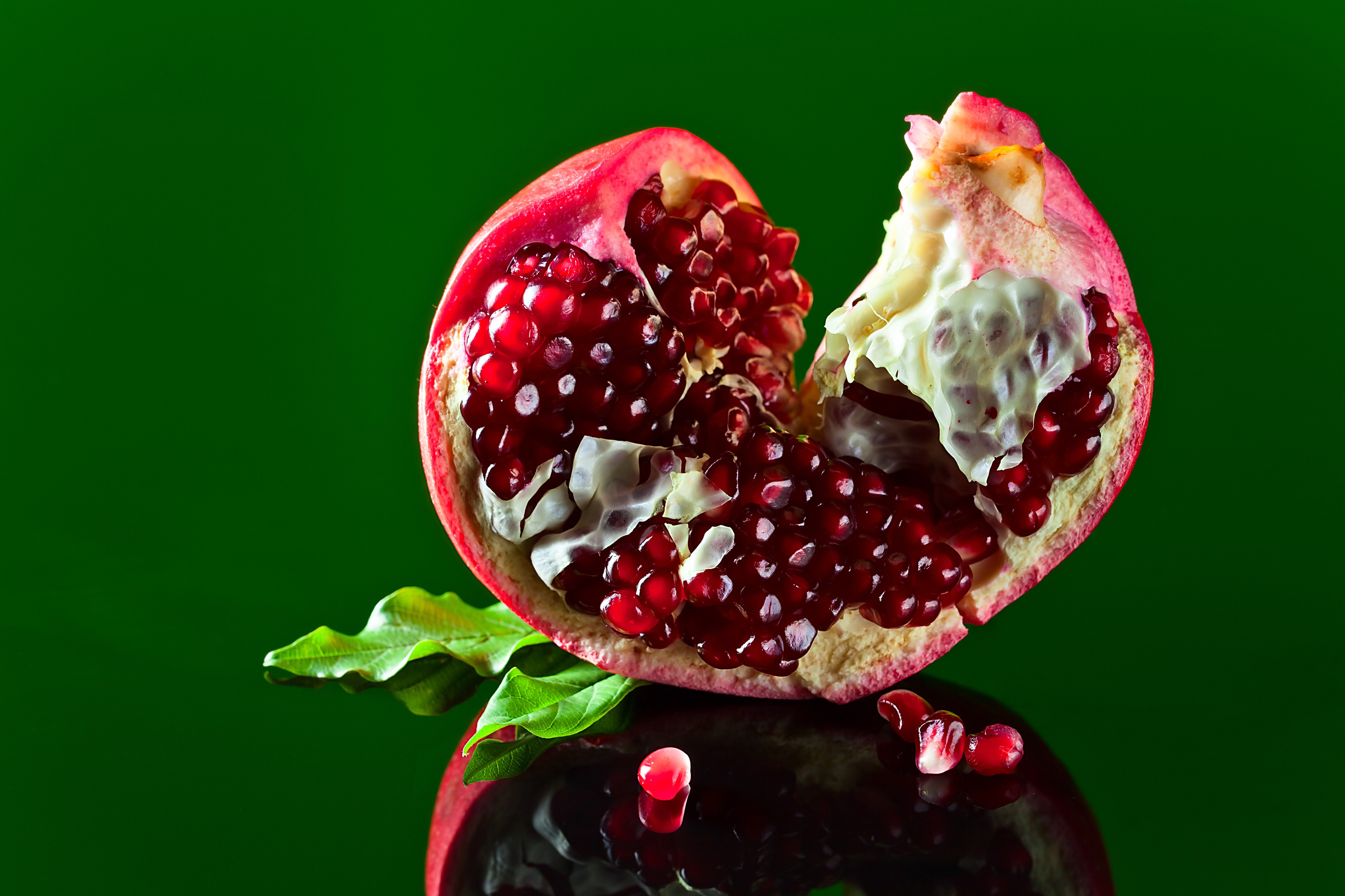 4K Pomegranate with Green Background HD Wallpaper
