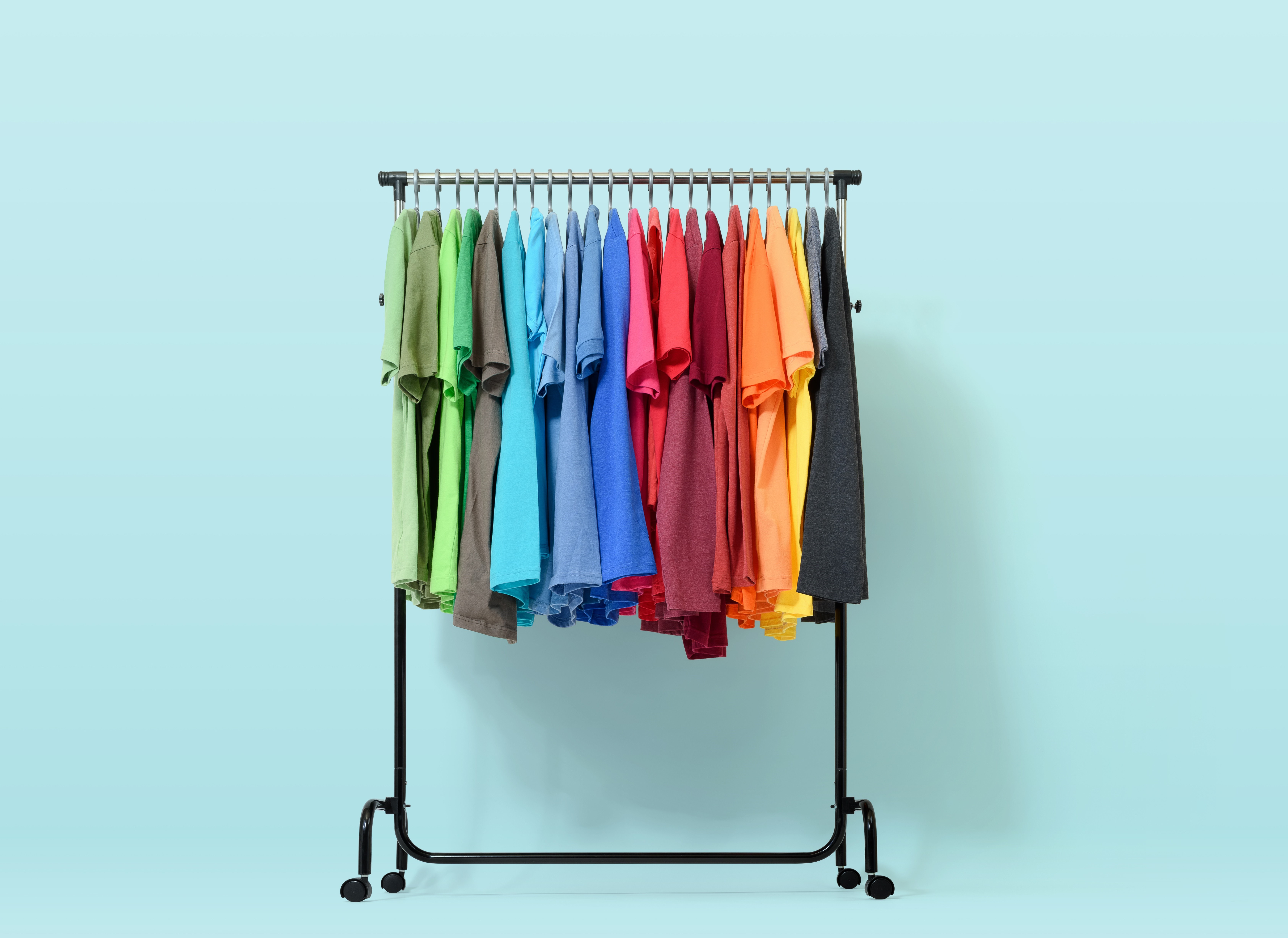 Multicolor T-shirts on a clothing rack HD Wallpaper