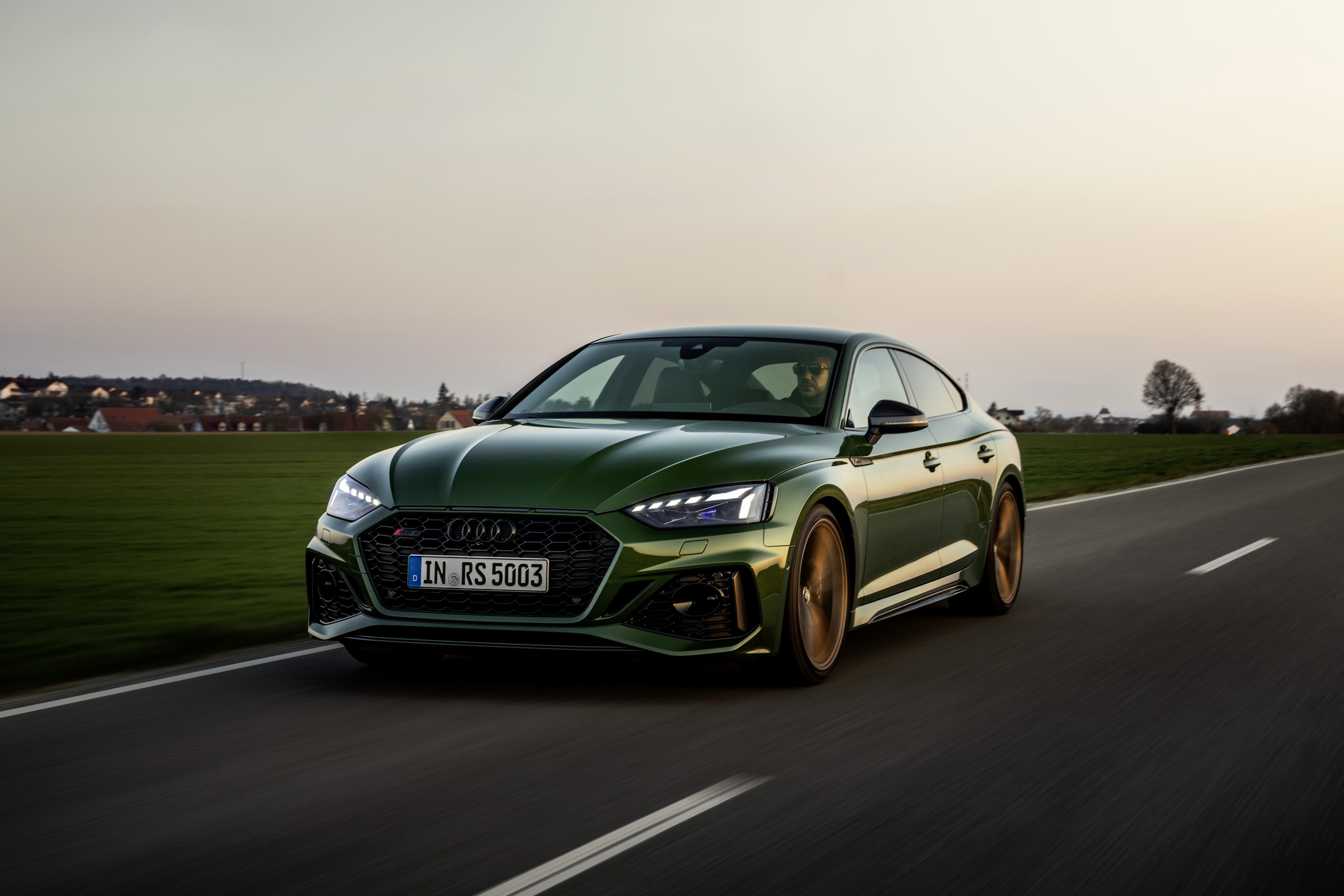 4K Audi RS5 Sportback driving on road HD Wallpaper