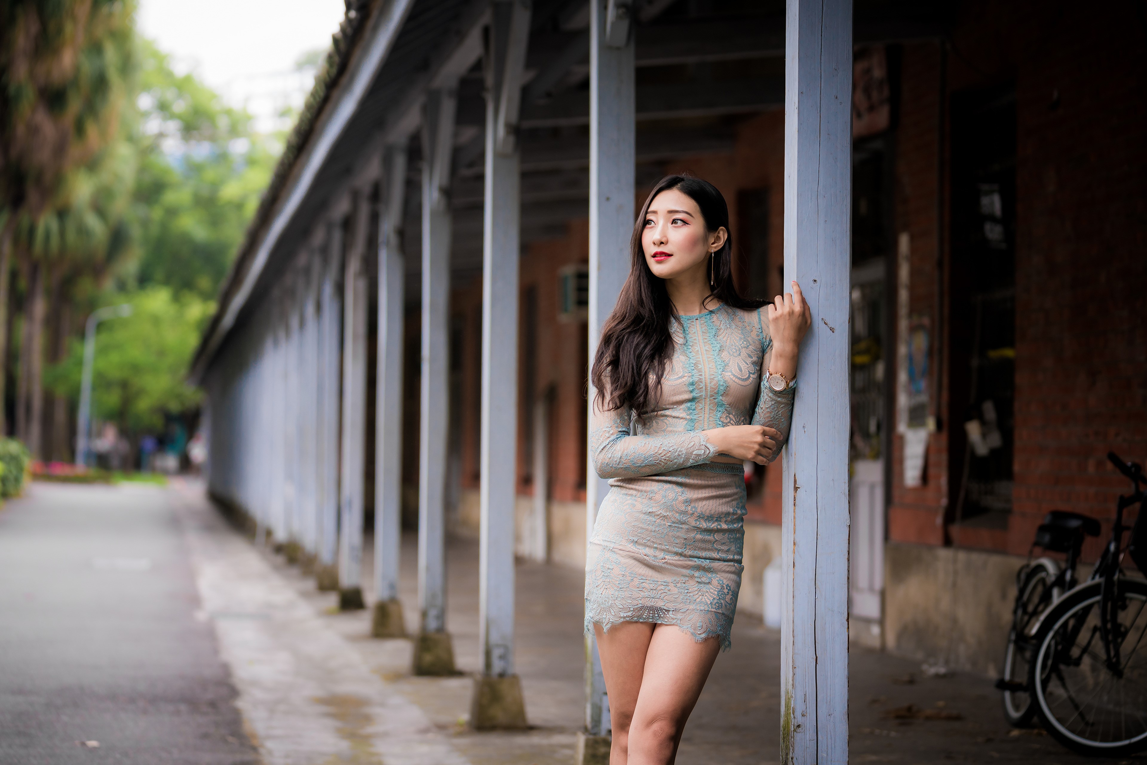 Asian woman in a dress standing by pillars HD Wallpaper