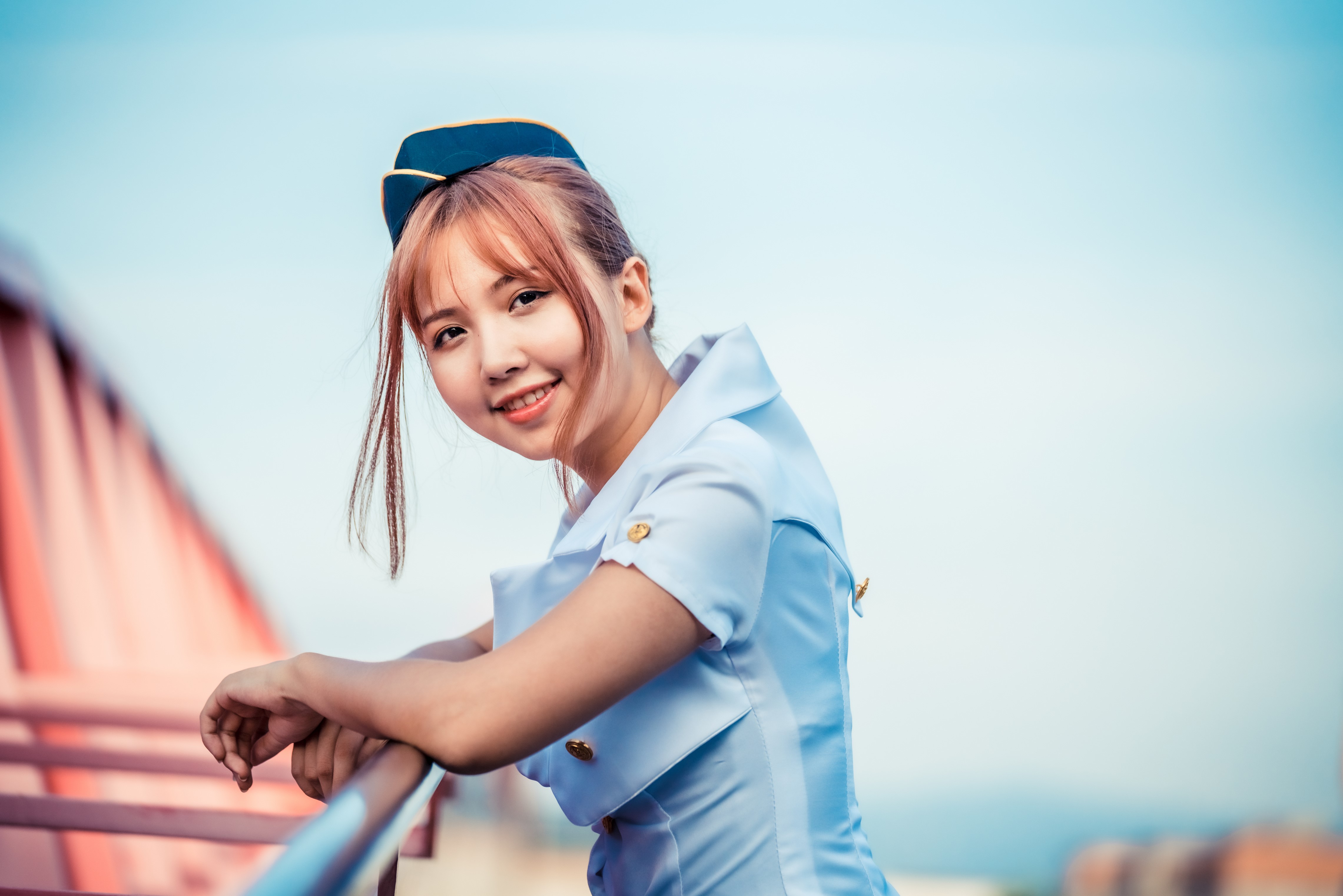 Asian stewardess in uniform smiling HD Wallpaper