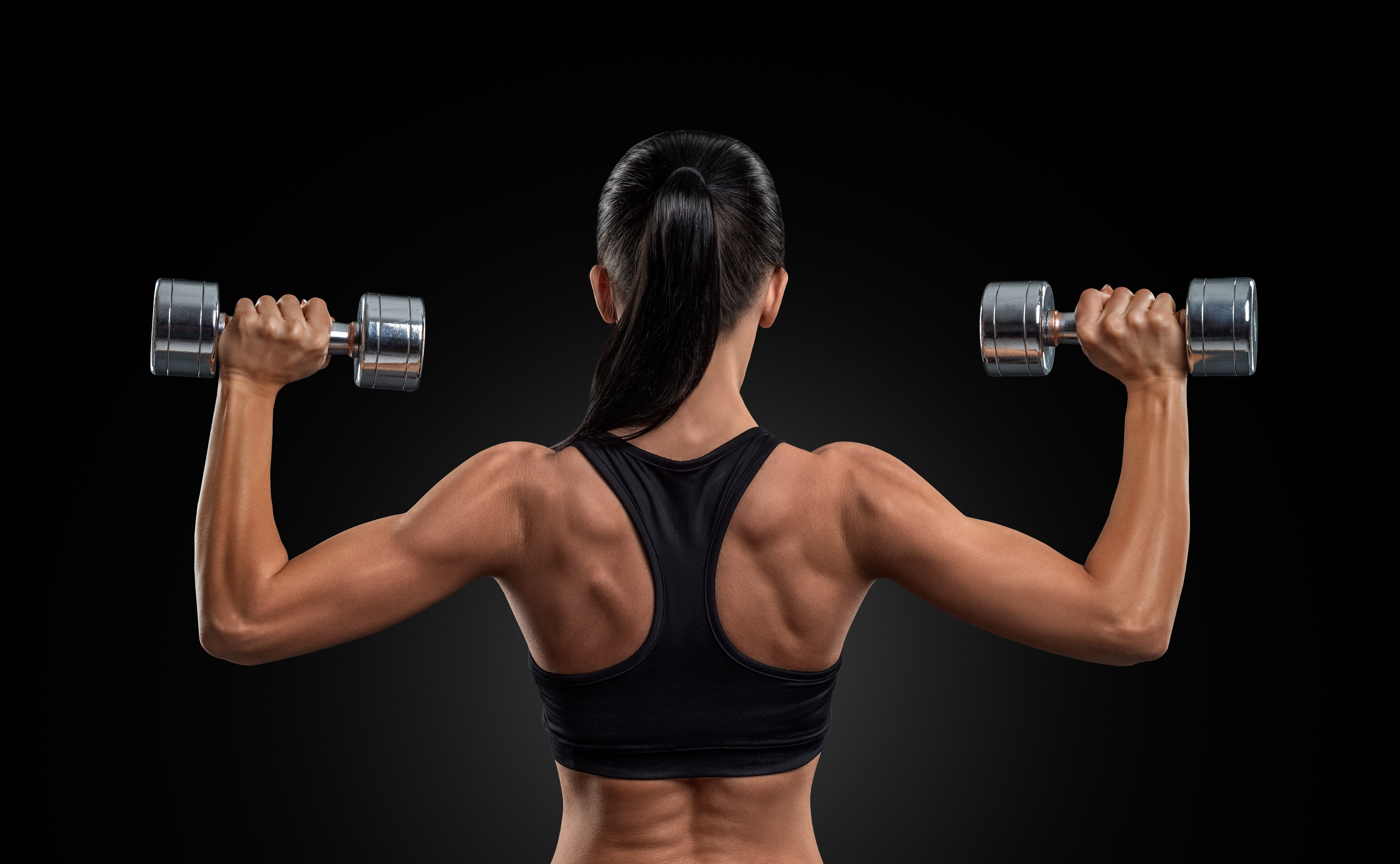 4K Fitness Woman Lifting Dumbbells Back View HD Wallpaper