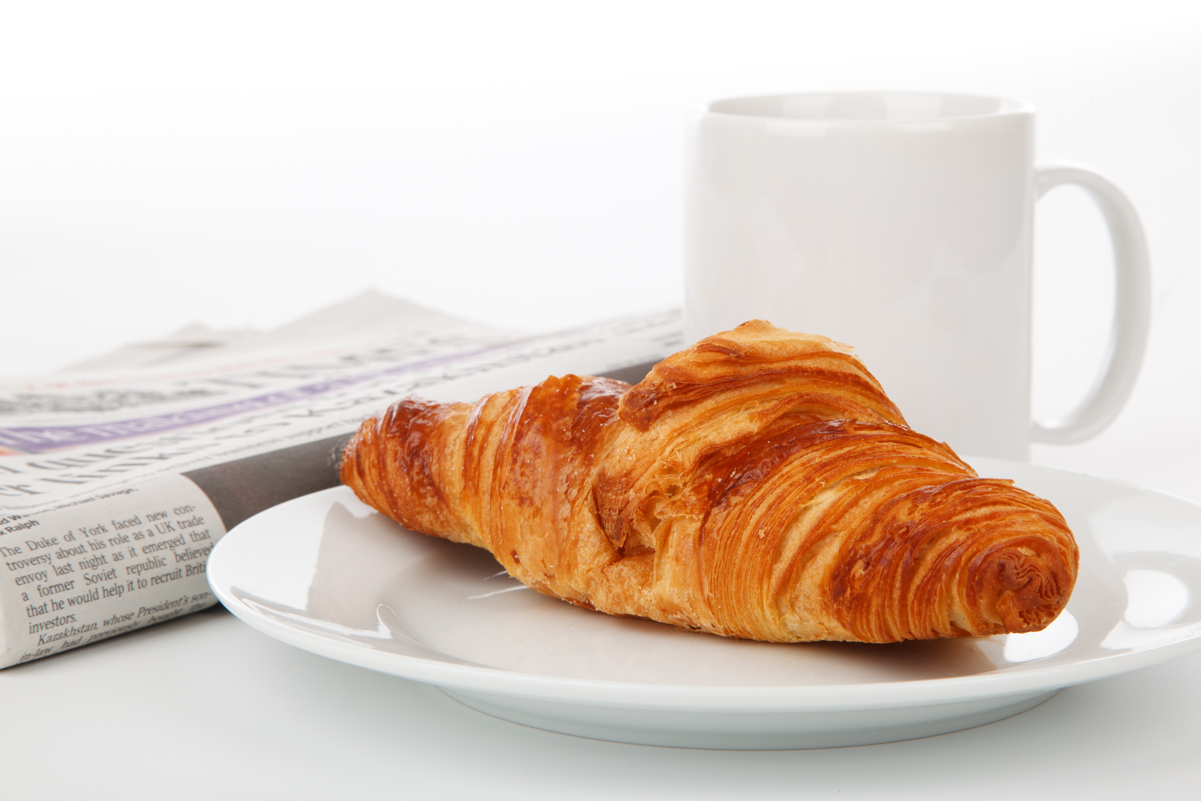 Croissant on a plate with a mug and newspaper HD Wallpaper