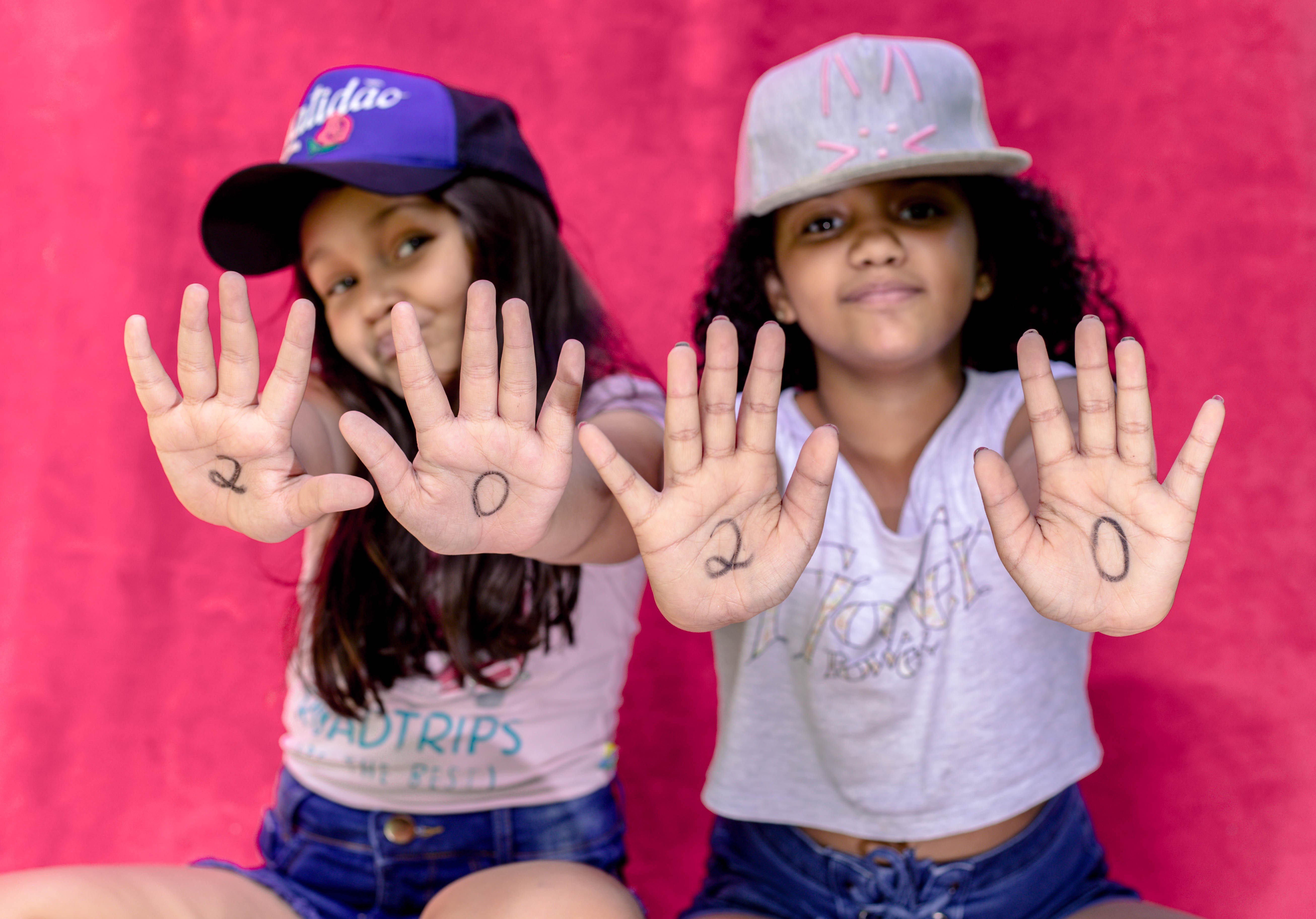 Two girls showing hands with numbers 2020 HD Wallpaper