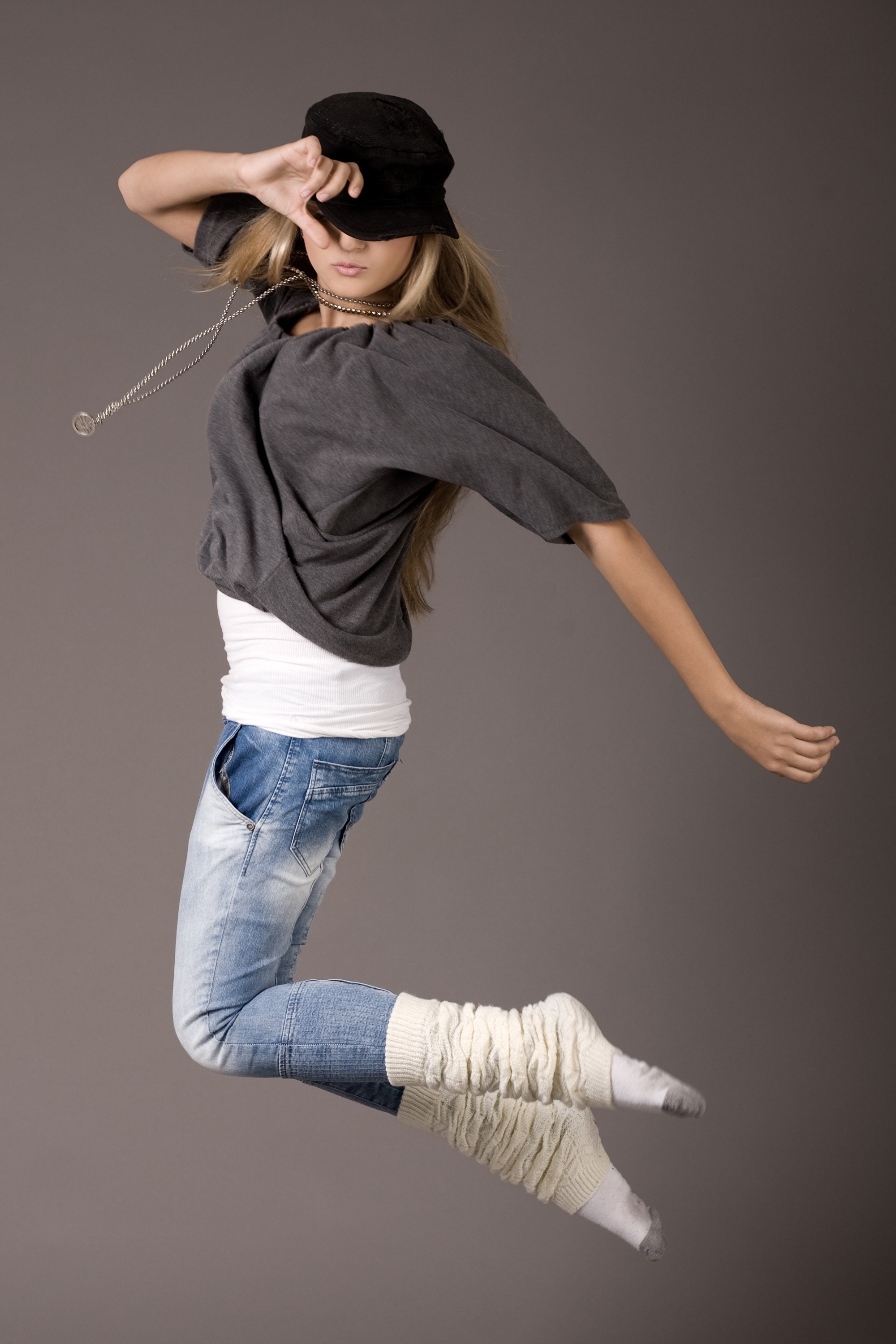 Girl in baseball cap jumping in jeans HD Phone Wallpaper