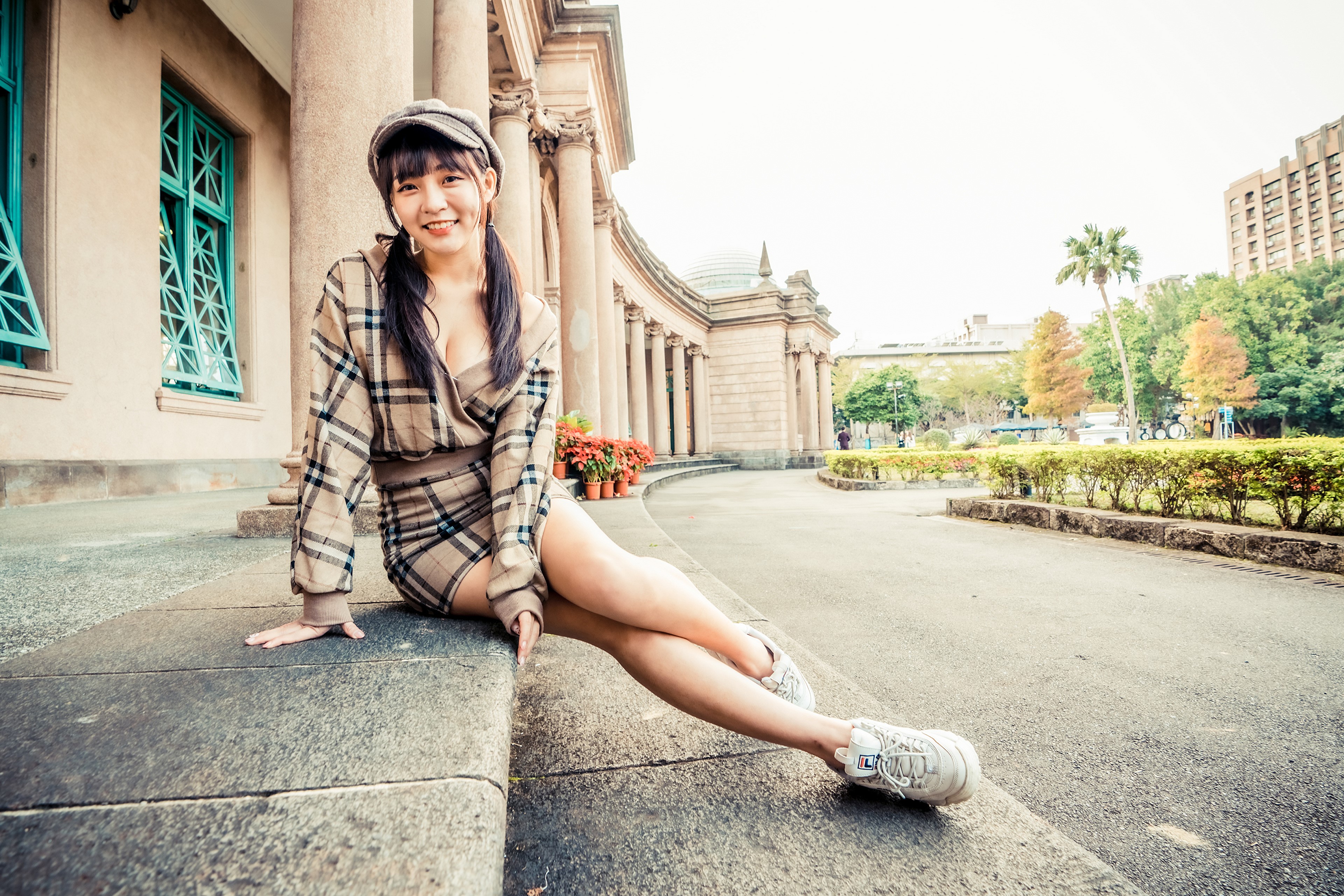 Asian woman in plaid dress and cap sitting HD Wallpaper